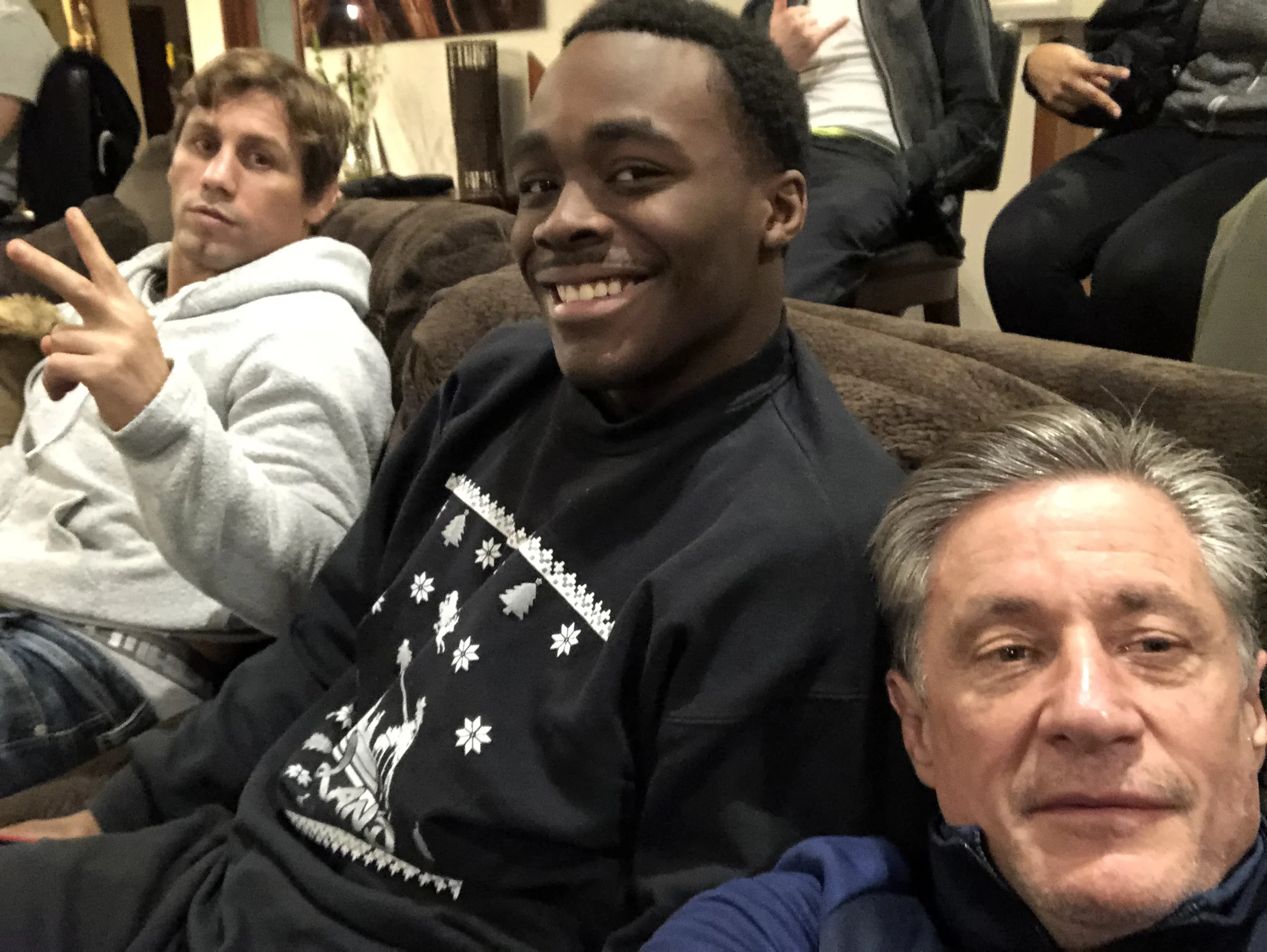 Urijah Faber, Denzel Mabry, and Kevin Dunn getting ready to watch an MMA event.