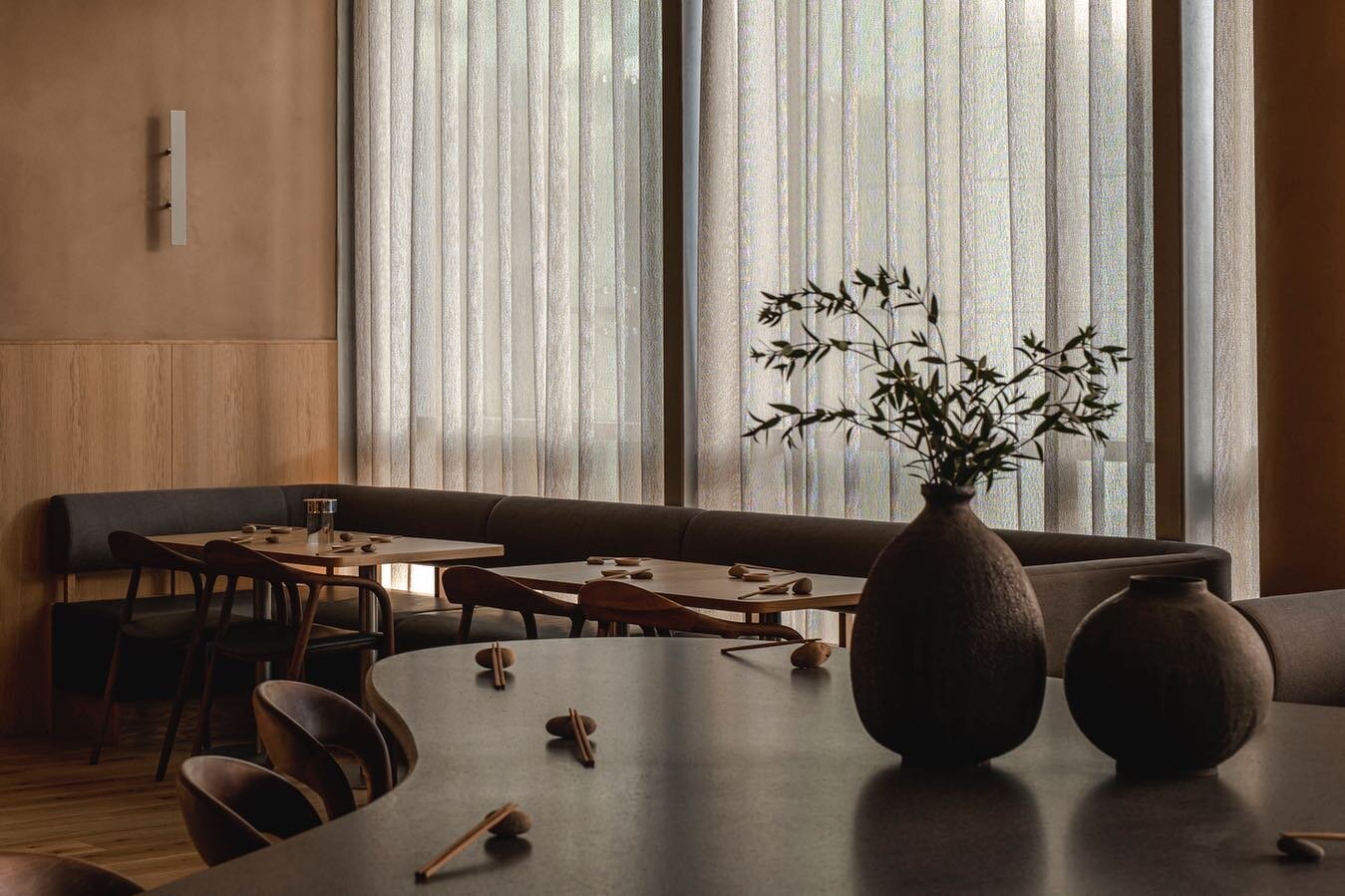 Loosely woven floor to ceiling curtains act to shield the guests from the buzz outside but allow the diffused morning light to trickle in. Seating is set deliberately low around the perimeter of the room for an intimate dining experience. 

#studioem