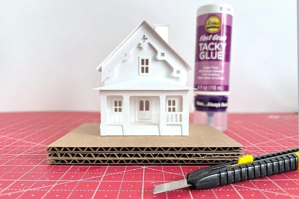 corrugated cardboard pieces and glue to make a putz house base.