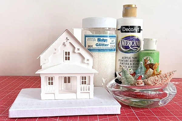 finished putz house base ready to decorate with paint, glitter, bottle brush trees and figures.