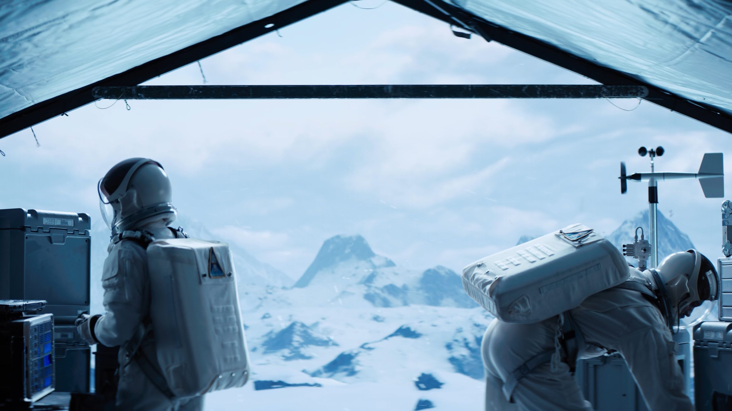 Two astronauts in white spacesuits working inside a research station with large windows overlooking snowy mountains and a cloudy sky.