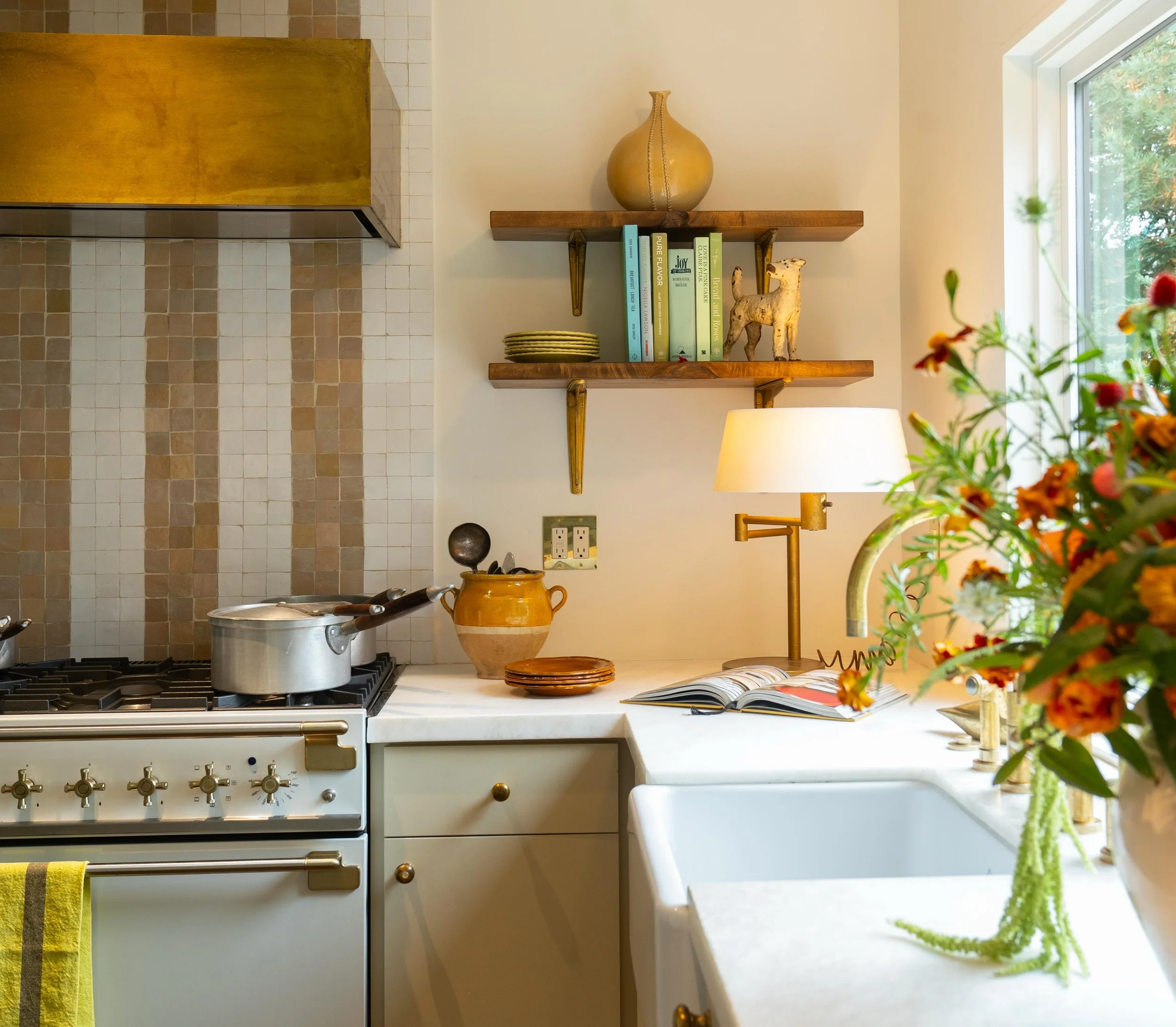 Details from the kitchen at my #CapitolaBeachBungalow project.&nbsp;

Highlights include a custom unlacquered brass hood, zellige mosaic backsplash, and Bianco marble counters.