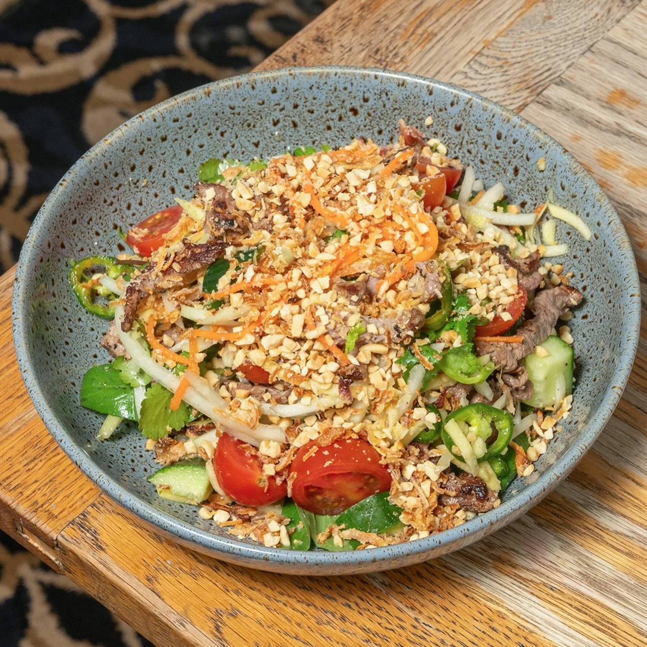 Our Thai Beef Salad is made for summer days: fragrant lemongrass beef tossed through papaya, juicy mango, carrot and shallots, all finished with peanuts, fresh herbs, chilli and a punchy tamarind dressing.

Light, vibrant and full of flavour, yet sti