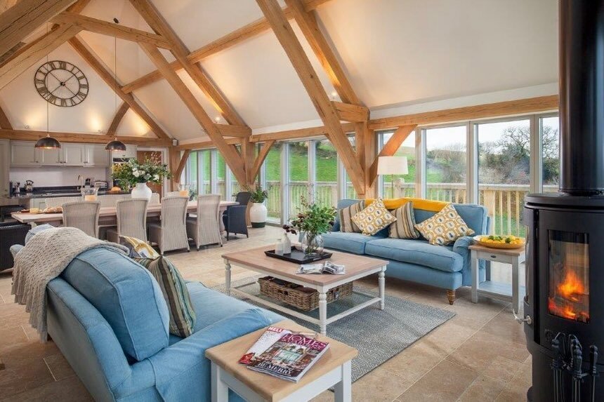 BARN LIVING: the main living rooms are open to the rafters and enjoy the warmth and character of exposed timber frames. A timber framed barn house provides enormous flexibility and accommodates life changes easily. #barn #barnhousestyle #barnhouse #o