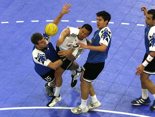 Mark Ortega (white jersey) squeezed in the middle