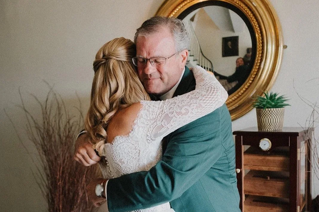 Bride sharing a warm embrace with her father on her wedding day.