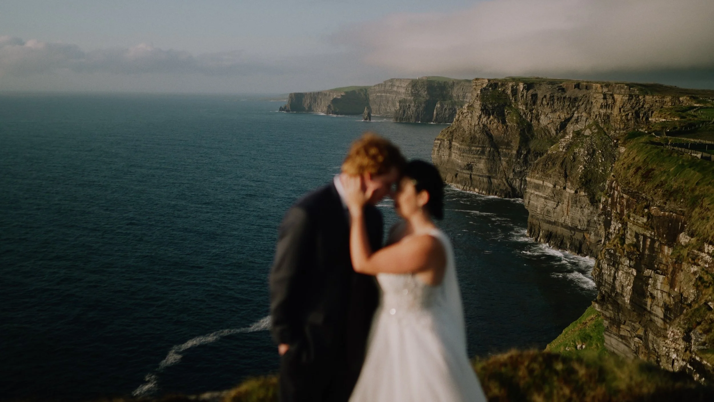 Elopement couple photographed with the Cliffs of Moher on the west coast of Ireland.