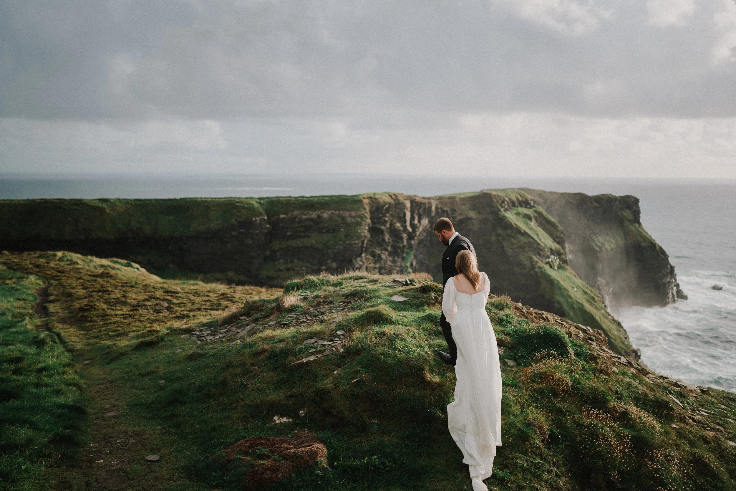 Couple exploring the Cliffs of Moher during their Ireland elopement