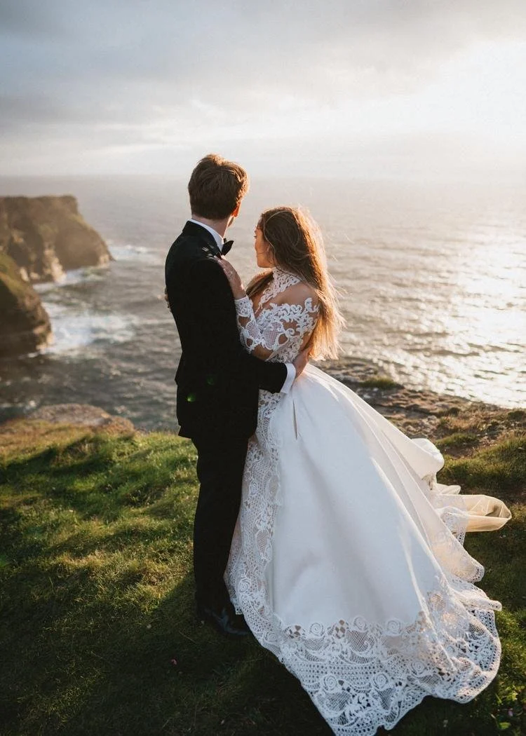 Newlywed couple overlooking the Atlantic Ocean during their Cliffs of Moher elopement in Ireland.