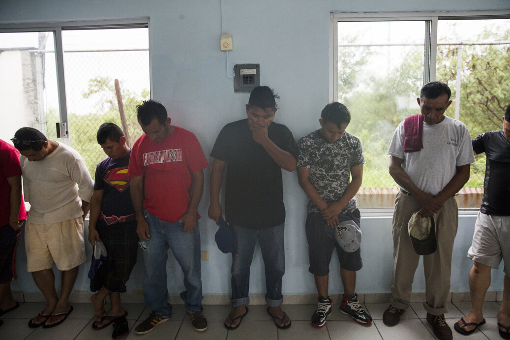 Families pray before lunch at the Senda De Vida Casa Del Emigrante, a center that houses immigrant families seeking shelter before crossing the border, on Wednesday, June 20, 2018, in the border town of Reynosa, Mexico. Many of the families said the