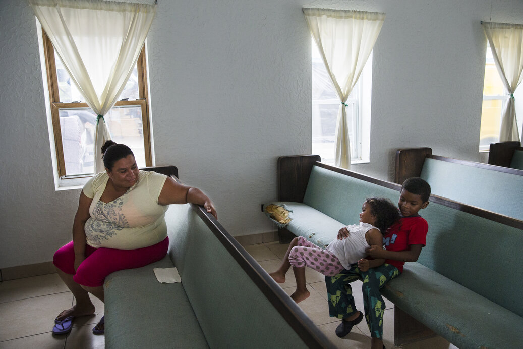  "Lorena," sits in the chapel at the Senda De Vida Casa Del Emigrante, a center that houses immigrant families seeking shelter before crossing the border, on Wednesday, June 20, 2018, in the border town of Reynosa, Mexico. "Lorena," whose family has 