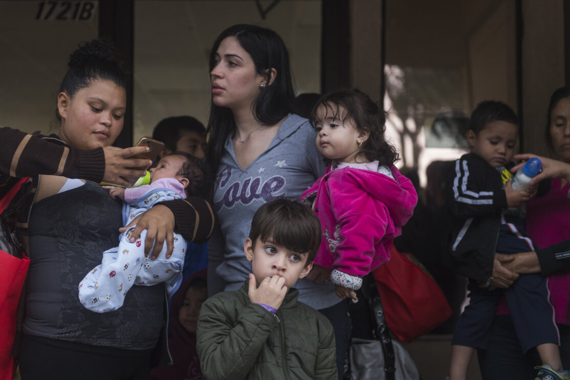Central American migrant families wait to be taken to the McAllen bus station from the Catholic Charities Humanitarian Respite Center on Tuesday, June 19, 2018, in McAllen, TX. The families were processed and released by U.S. Customs and Border Prot