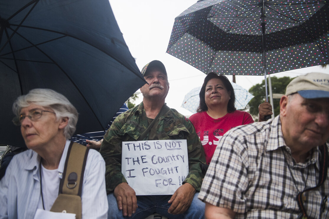 Ruben Yzaguirre, middle, attends a Vigil and prayer walk at Archer Park on Wednesday, June 20, 2018, in McAllen, TX. Participants walked from the park to the federal courthouse a few blocks away, in honor of immigrant families and children who have