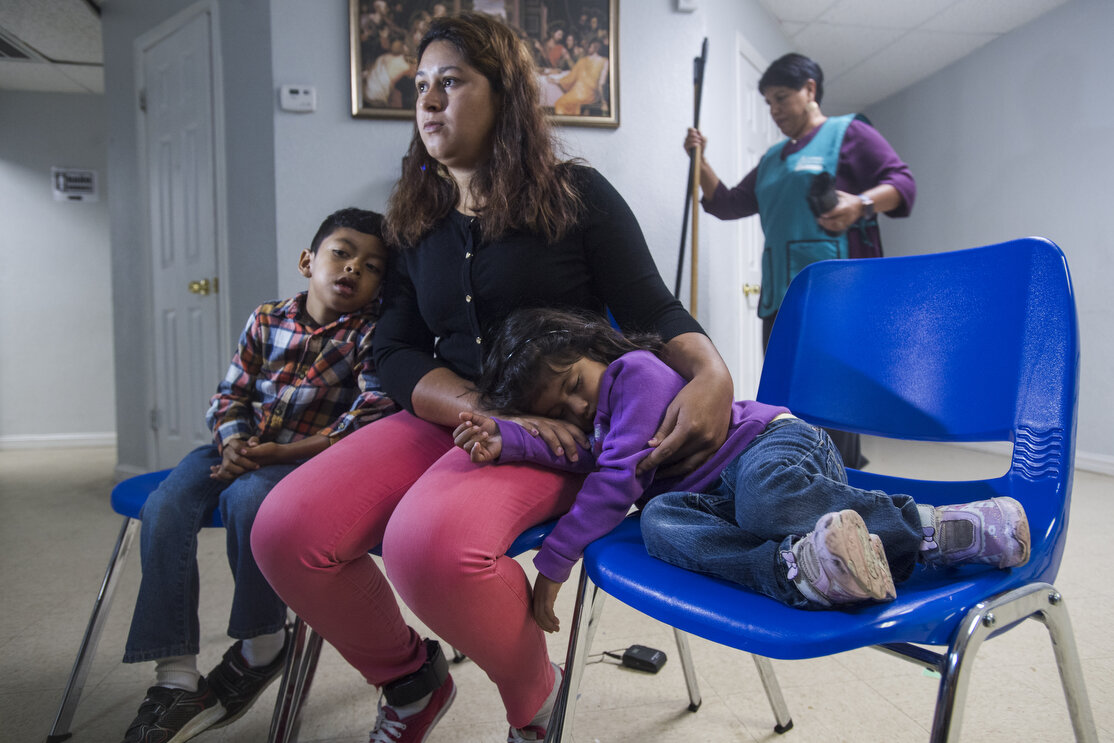 "Lucia" speaks about her experience of fleeing her home country of Guatemala and crossing the border into the United States. Her children rest at her side at the Catholic Charities Humanitarian Respite Center on Tuesday, June 19, 2018, in McAllen, T