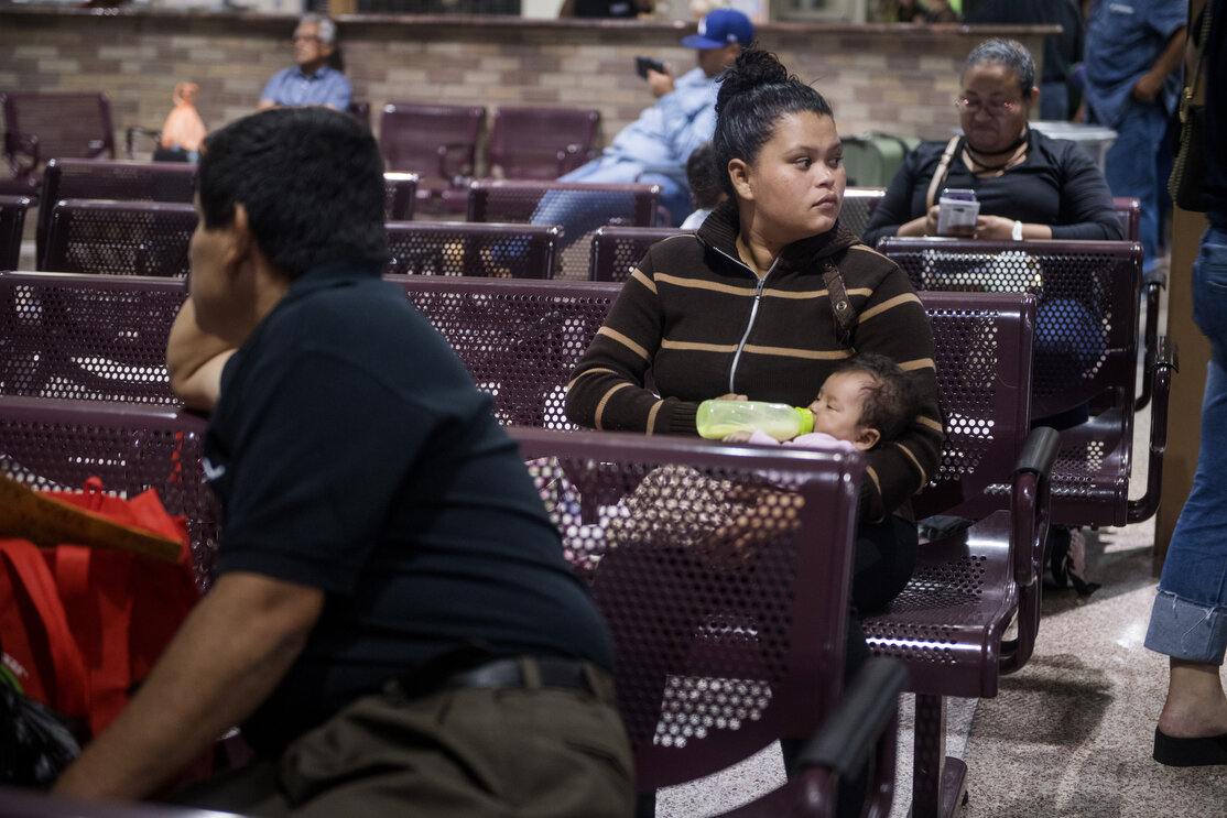 Daniela Gabriela Ramos, 21, waits with her infant daughter for her bus at the McAllen bus station after leaving border patrol processing and the Catholic Charities shelter on Tuesday, June 19, 2018, in McAllen, TX. Ramos fled violence in Honduras wh