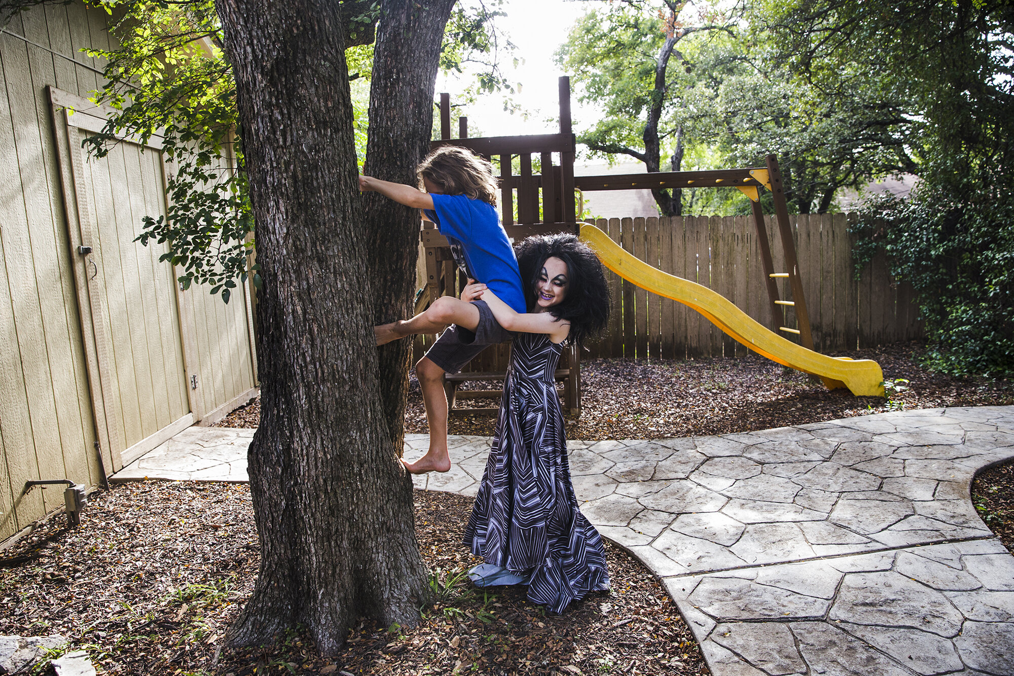  Keegan plays with his older brother, Noah, outside their family home following a drag lesson at the queens house. His parents say that Keegan would often remain in full drag until bed time after one of the lessons. 