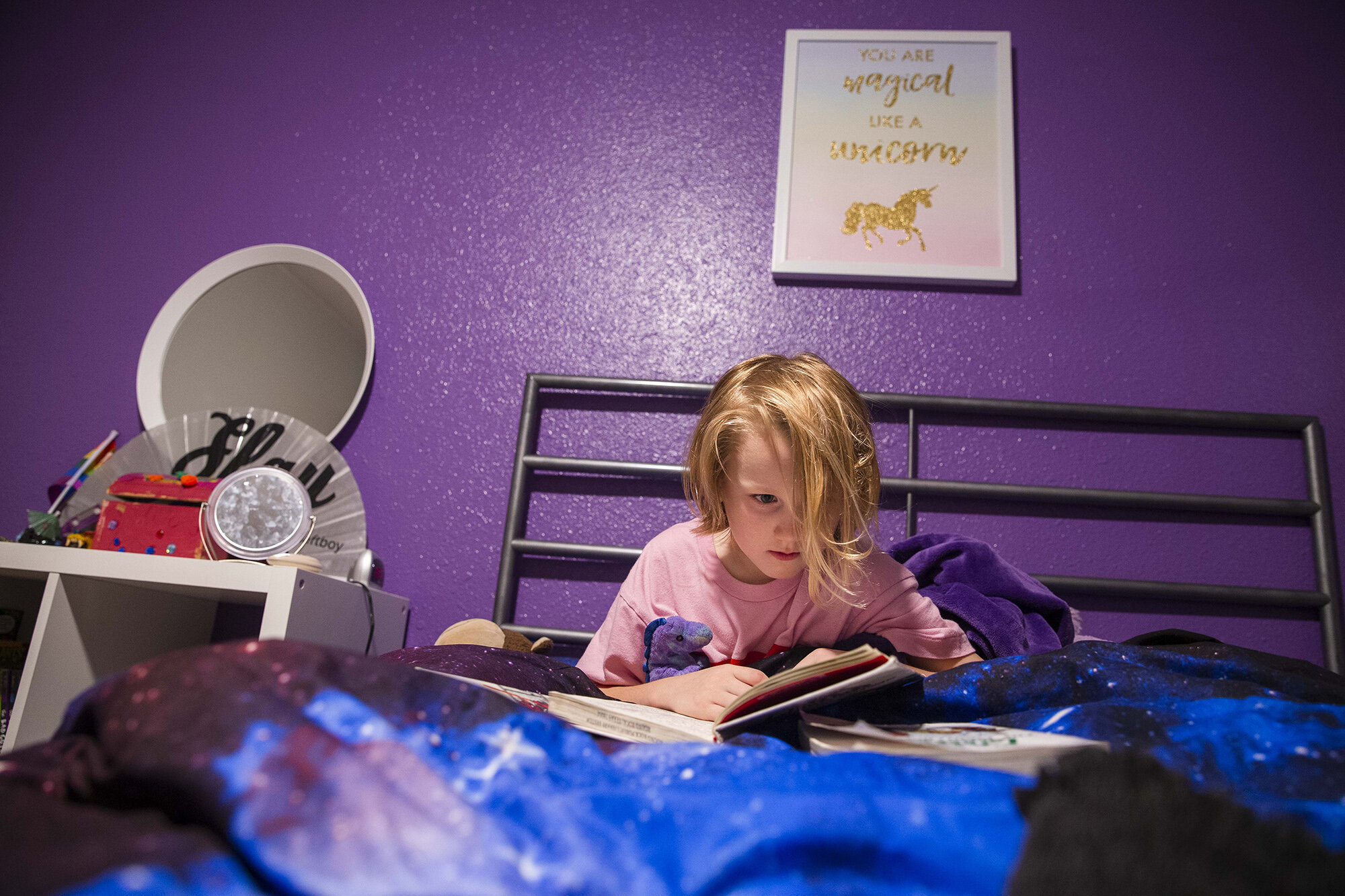  Keegan reads before going to sleep in his room painted in his favorite color purple. 