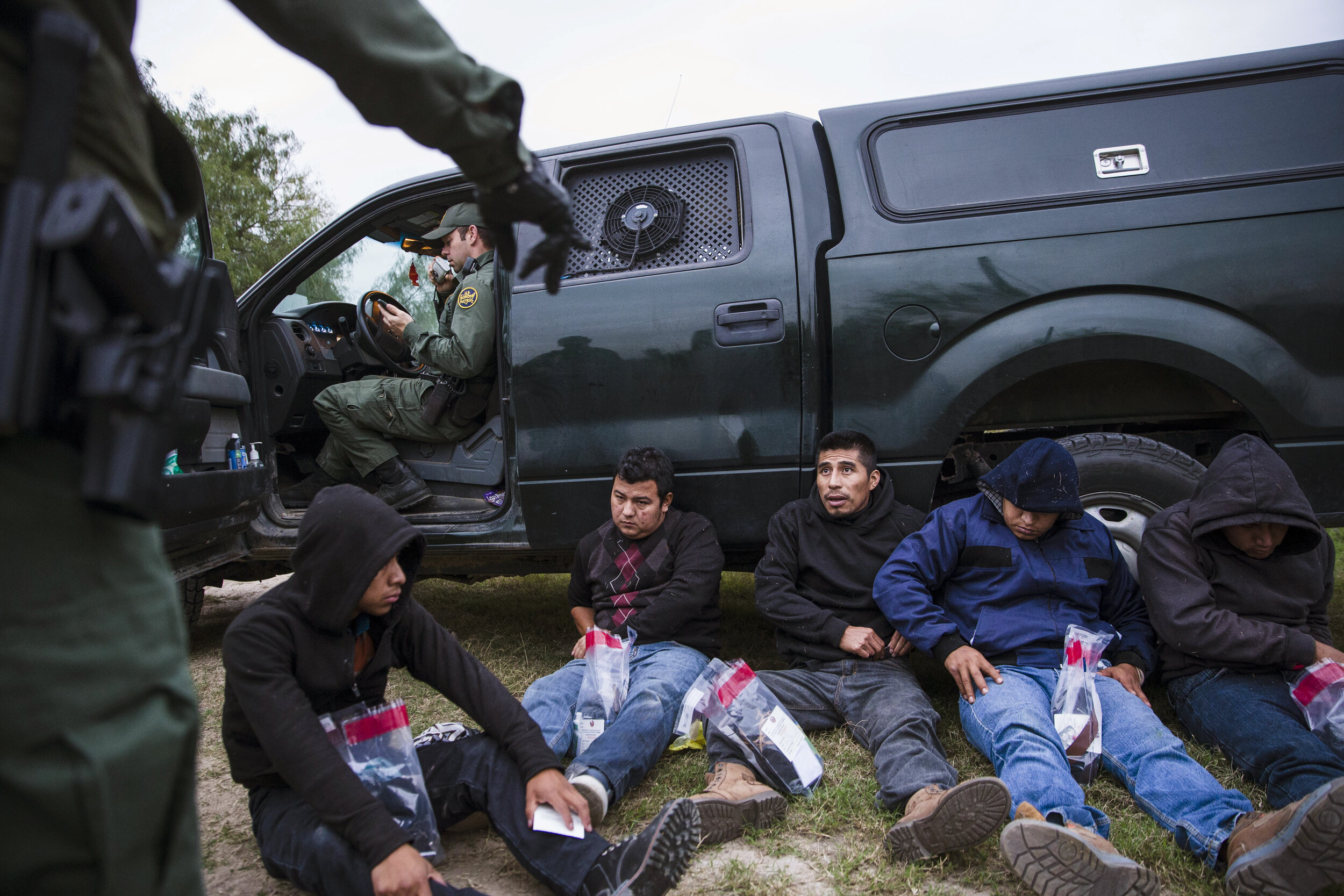  A group of immigrants from Guatemala, Honduras and Mexico are taken into custody by Border Patrol Agents after being apprehended crossing the border from Mexico into the U.S. on Wednesday, Dec. 5, 2018, near McAllen, TX. 