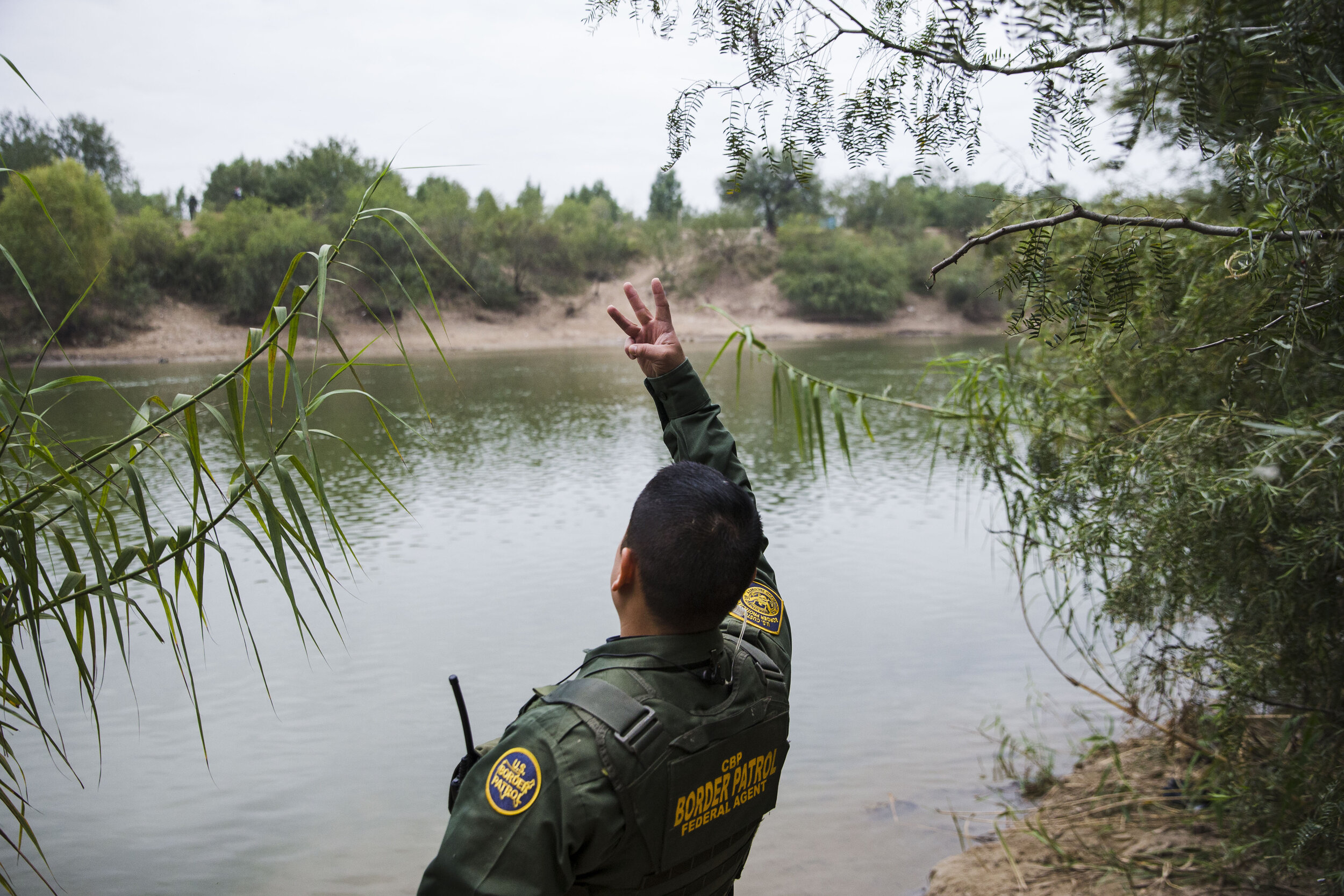  Border Patrol Agent Marcelino Medina signals across the Rio Grande River to the Mexican Military while patrolling for illegal border activity on Wednesday, Dec. 5, 2018, near McAllen, TX. 