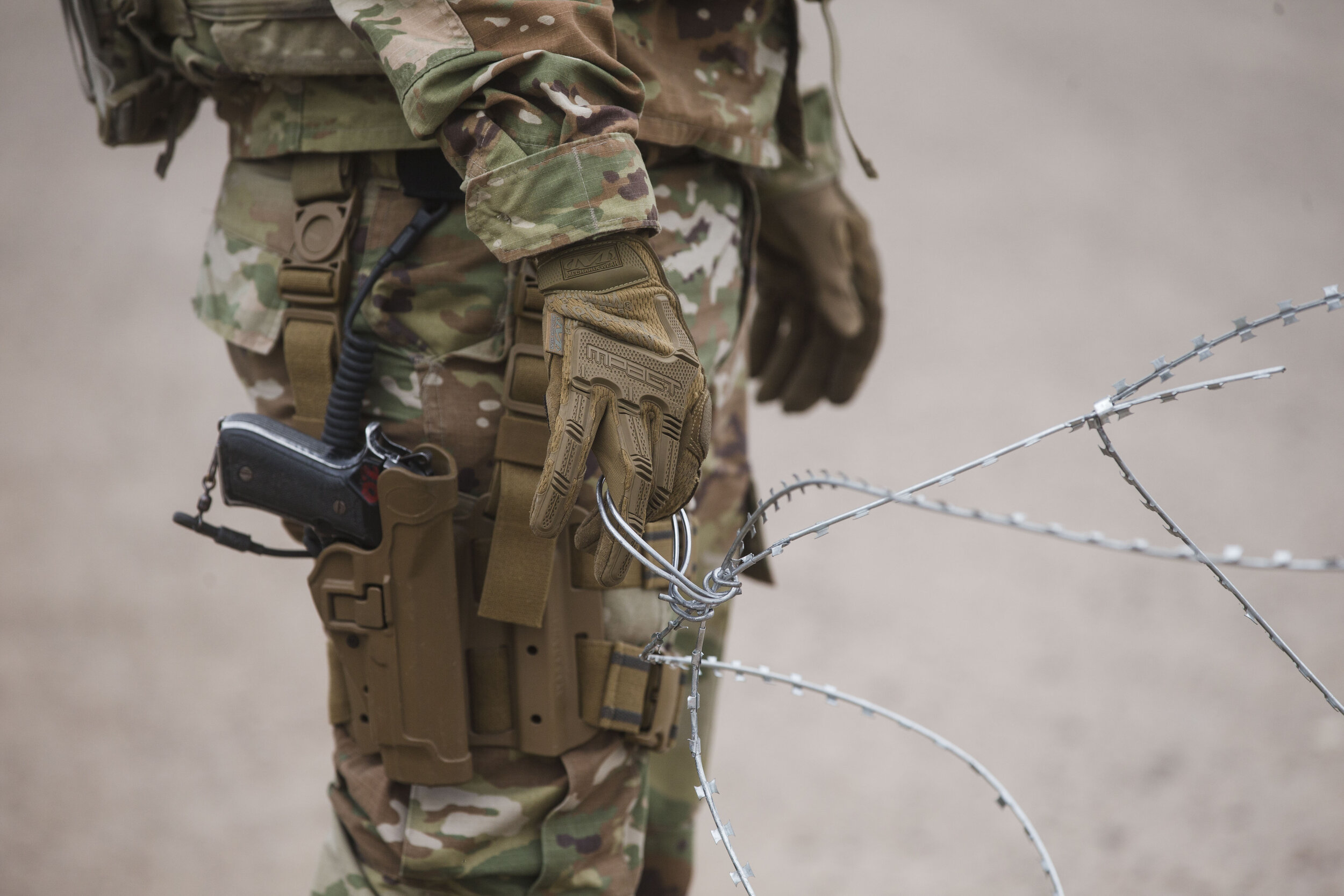 U.S. Army troops deployed to the U.S.-Mexico border in Texas set up a Military camp at the old Craig's Furniture in Weslaco, TX. Army personal use barbed wire as barrier gate at the entrance to the camp on Wednesday, Dec. 5, 2018. Defense Secretary 