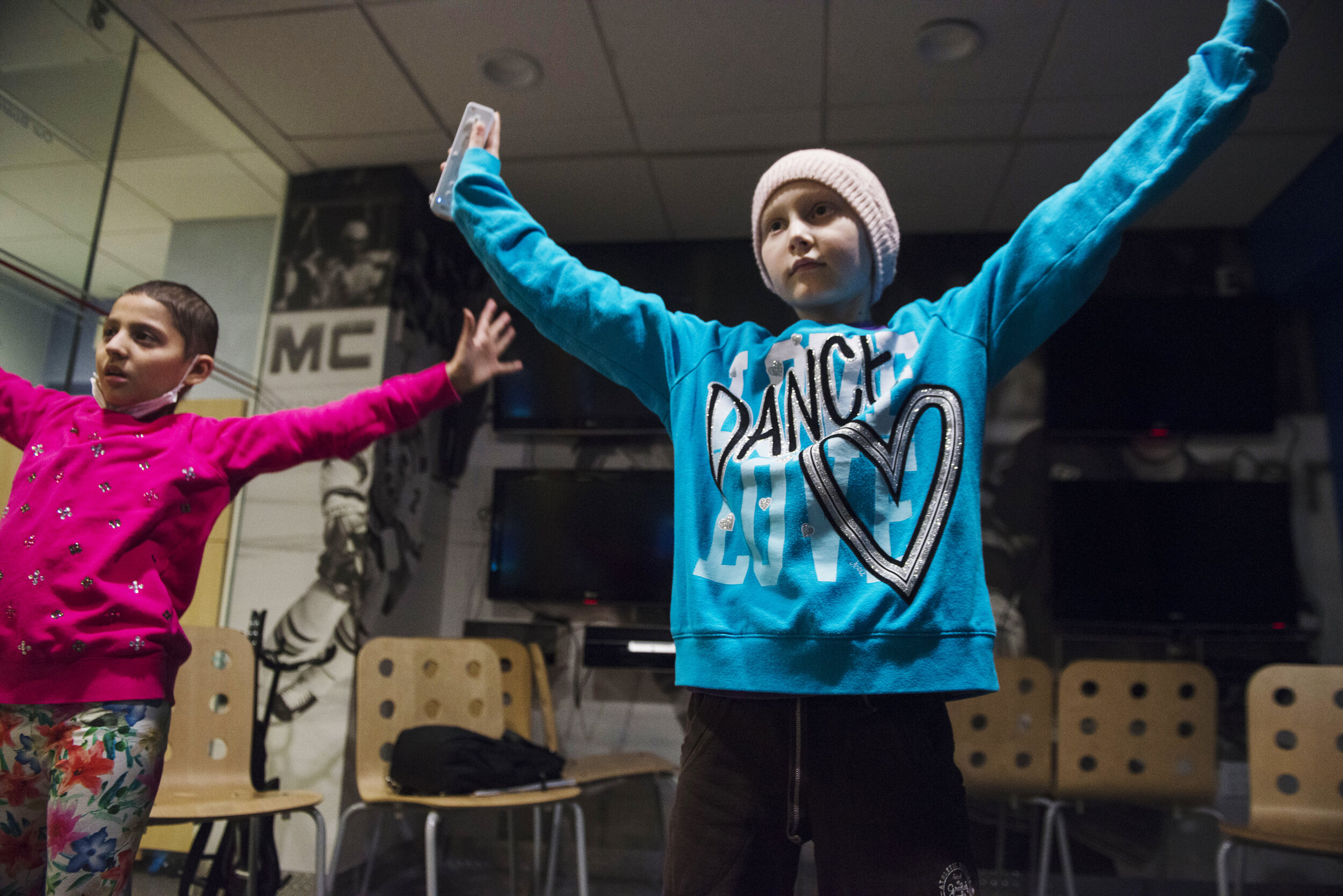Peyton, right, and Myrrah Shapoo, 10, dance while playing video games in the playroom of the Ronald McDonald House.
