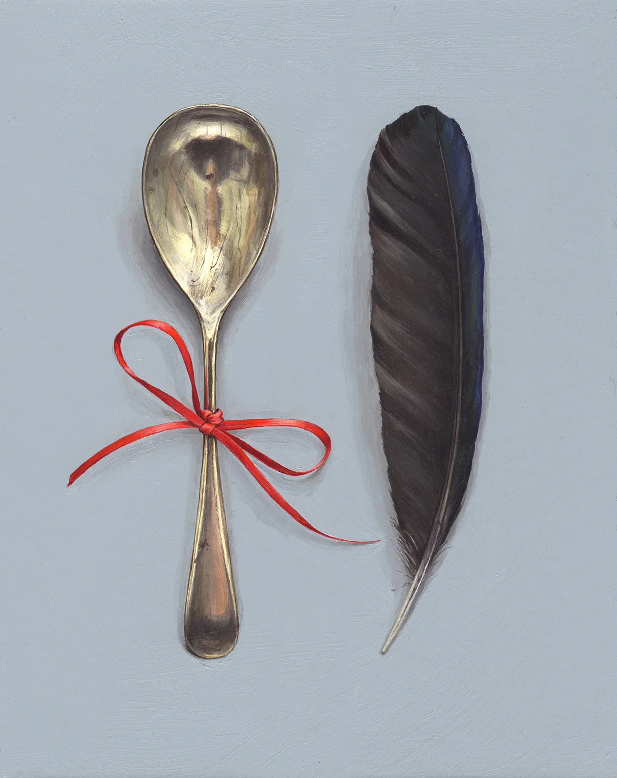 feather with spoon and red ribbon