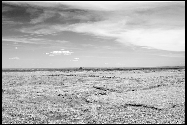 The View of Denver from the Former 903 Pad Thousands of barrels of wastes from the production area had been stored outside in a field called the 903 Pad. During the decades of production at the nuclear weapons plant, there was no designated place to dispose of the contaminated wastes and byproducts of the production processes. At one time, the plant operators injected wastes into the ground, and buried wastes in barrels around the 25 square mile site. These conditions contributed to the decision to demolish the plant and remediate the site. The decision to designate the site a “wildlife refuge” was made because that designation afforded the lowest standard of site cleanup and remediation. Many doubted the site could ever be fully cleaned, and controversy has surrounded the decision to allow the public into the resulting refuge.