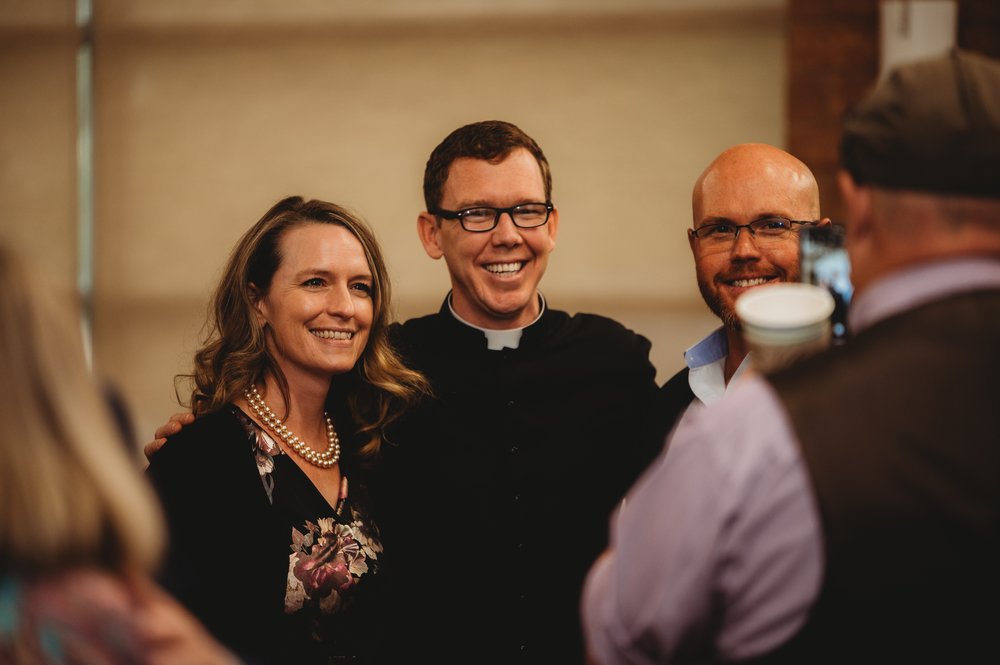 Sarah and Brandon Nelson with Fr. Carl Wertin.jpg