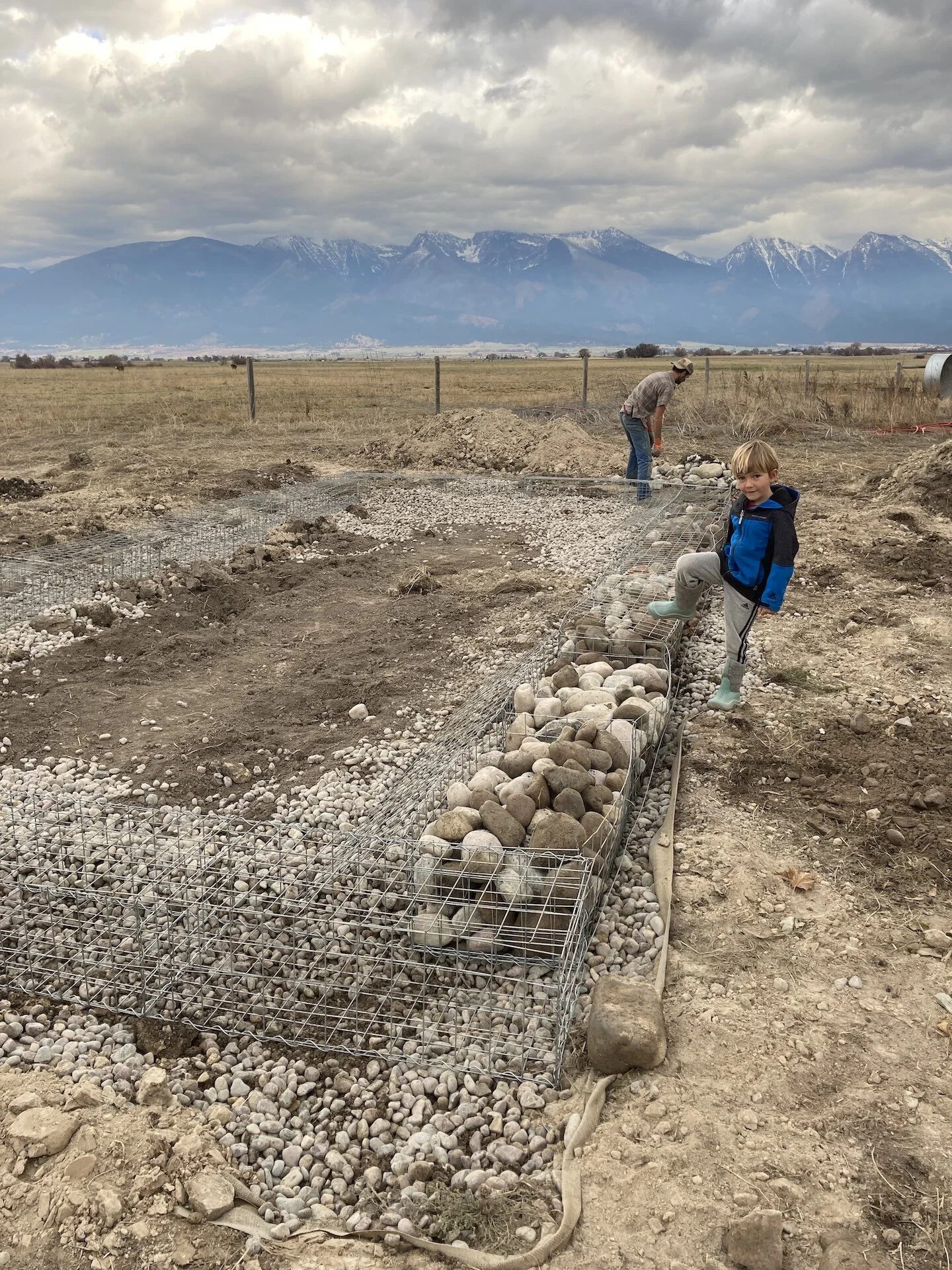  Gabions being filled with larger rock.   