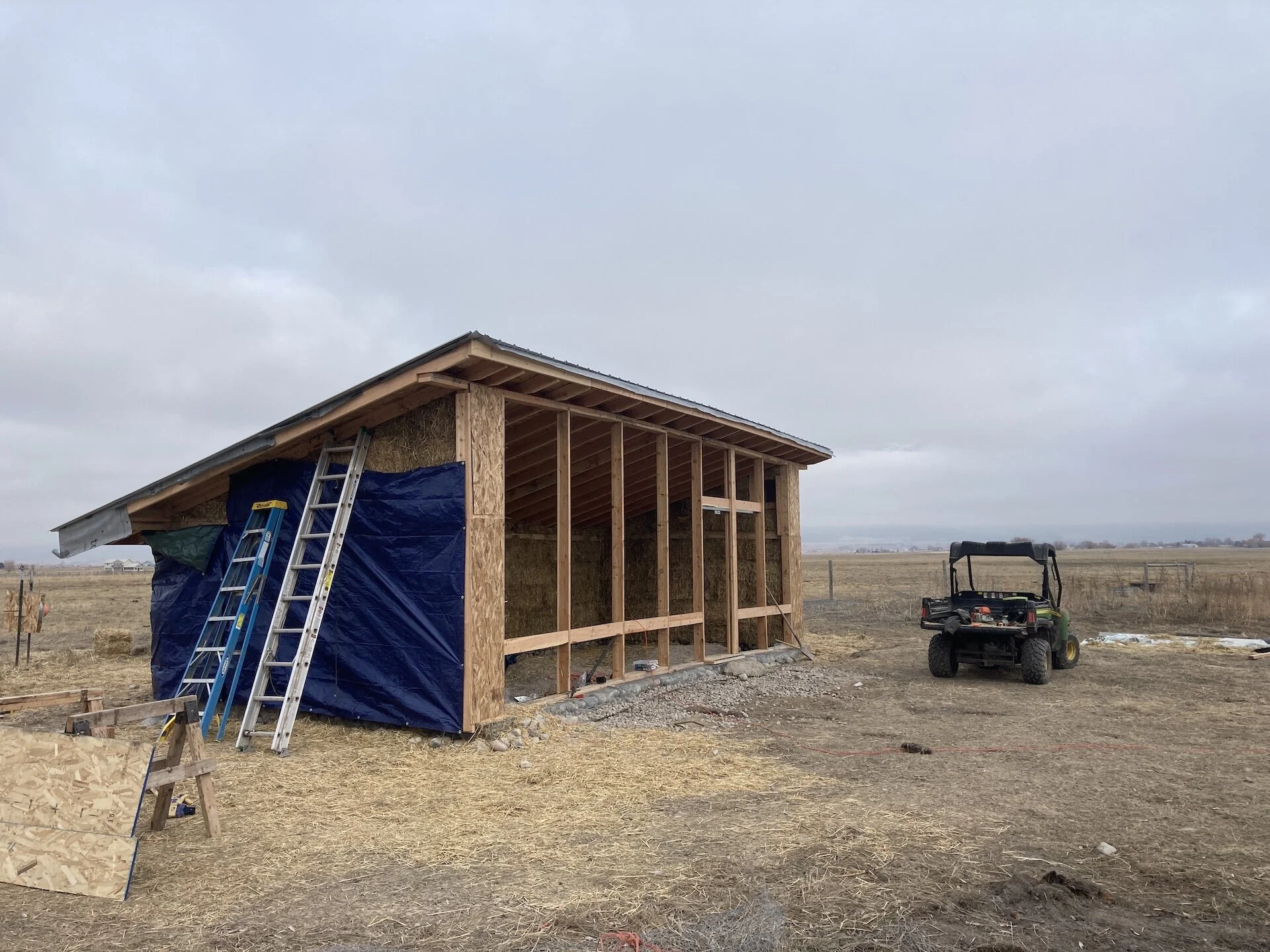  On the rafters was OSB, roof sheeting and then metal panels.  While we completed inside mudding during the winter, outside mudding would need to wait for spring when temps were warmer.  We covered the outside in tarps to keep any precip off of the b