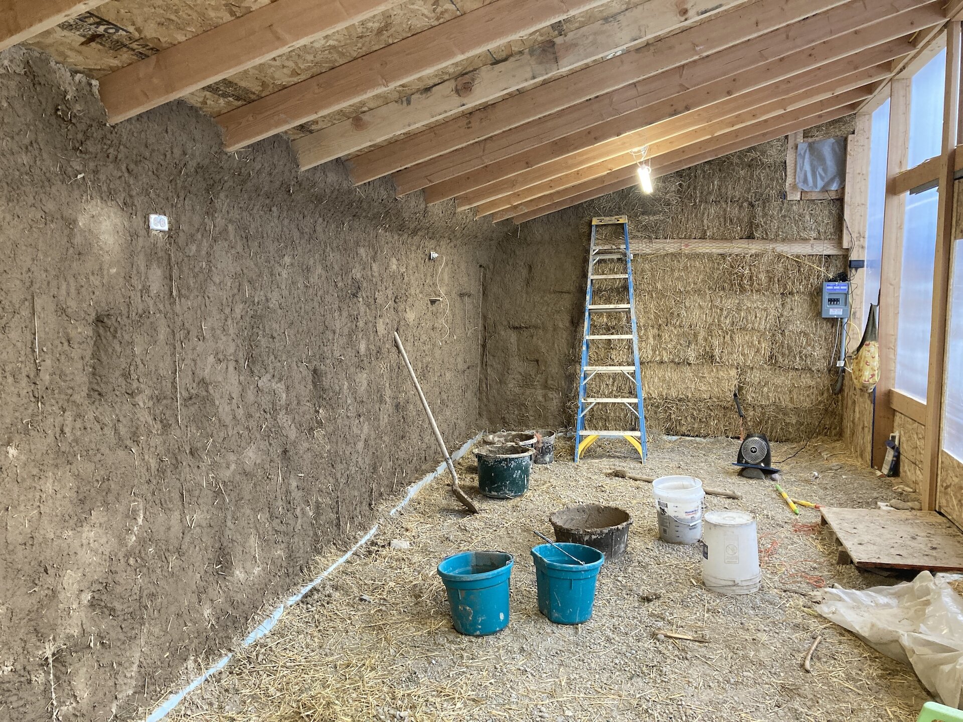  Nearly mudded!  Note the wires protruding from the walls.  These are high-tensile wires preloading the walls between the top cap and the gabion cages; this is a highly structural component of the load bearing walls.  On the right is the electrical s