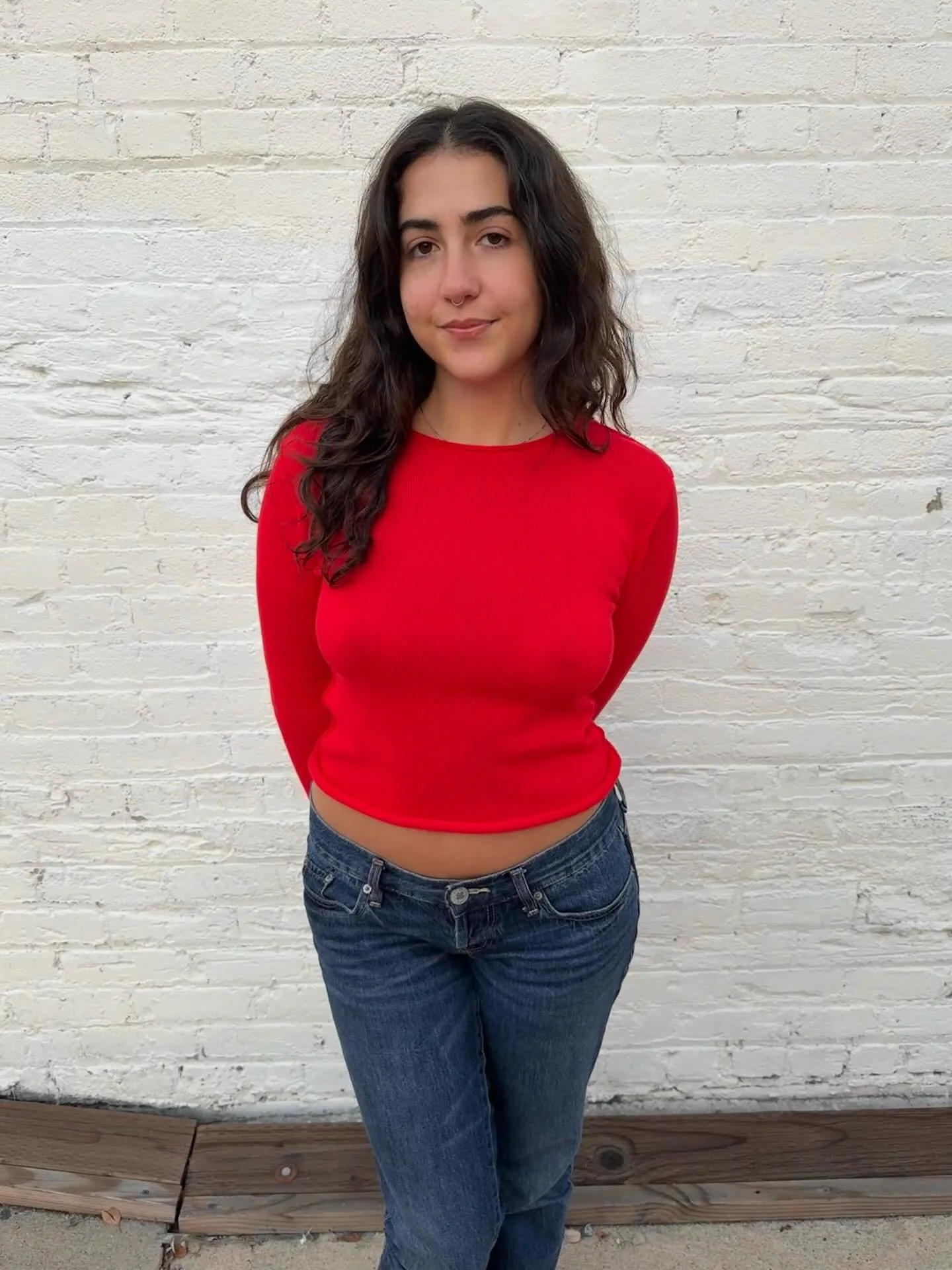 Celia girl wearing our perfect tomato red small batch sweater!!! A few sizes left!! We&rsquo;re loving that you&rsquo;re loving them aka all of us who have them wear them for at least 4 days in a row in between washing. Order now for Christmas delive