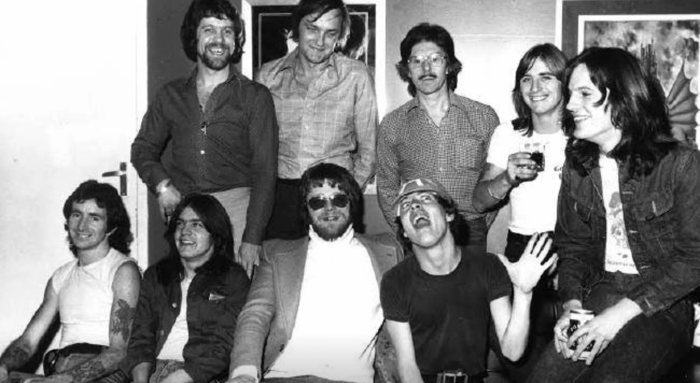 Meet and greet… AC/DC and manager Michael Browning meet The Beatles’ press officer Derek Taylor (back row, middle).