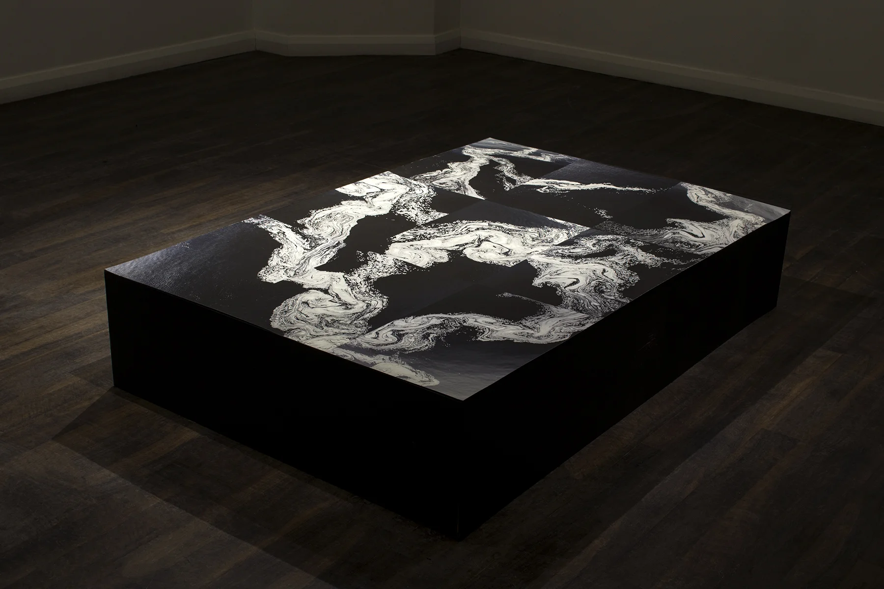 Surfactant, Inkjet Print on Plinth, 63’’x42’’x 18’’ (2017) Surfactant explores the aesthetic beauty of the Ottawa River and its seasonal change through the photographic lens. This work uses photo collage as a way to achieve a perspective foreign to reality while simulating the realistic detail of documentary photography. The work seeks to engage in the relationship between photography and science, while simultaneously opening a dialogue with painting. The image references the flattened surface and gestural form of abstract expressionism; but it exchanges the ethos of the gestural human hand for the mechanical eye of the camera.
