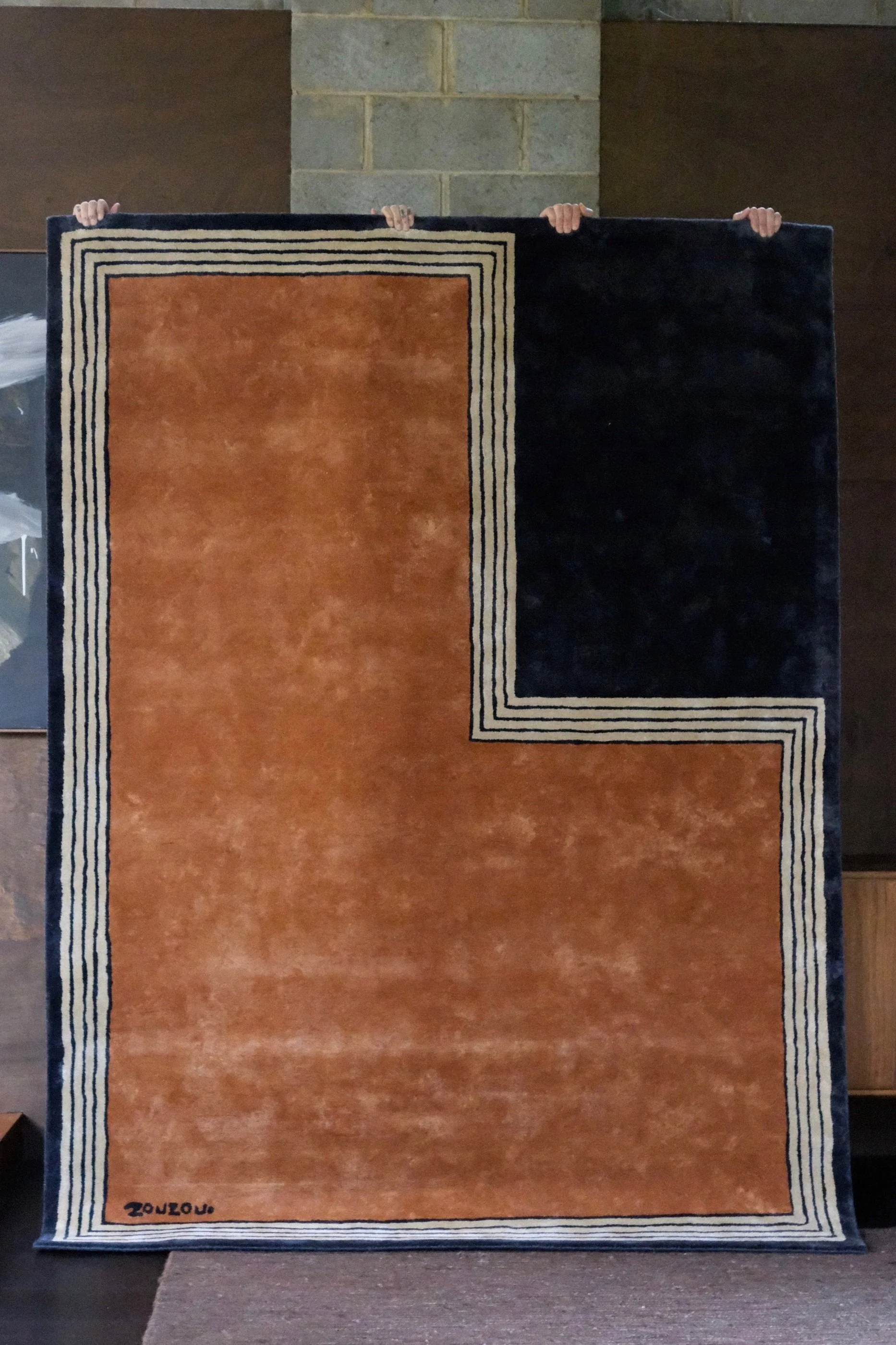 ZZ-10-003 Rust and black hand-tufted rug in New Zealand wool or bamboo silk, designed with bold L-shape contrast and layered borders for modern global interiors