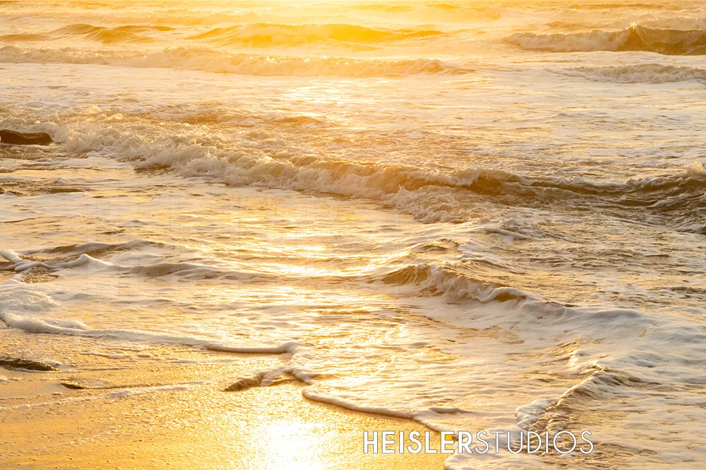 The golden sunrise reflecting off the waves. Taken at Wasghingto