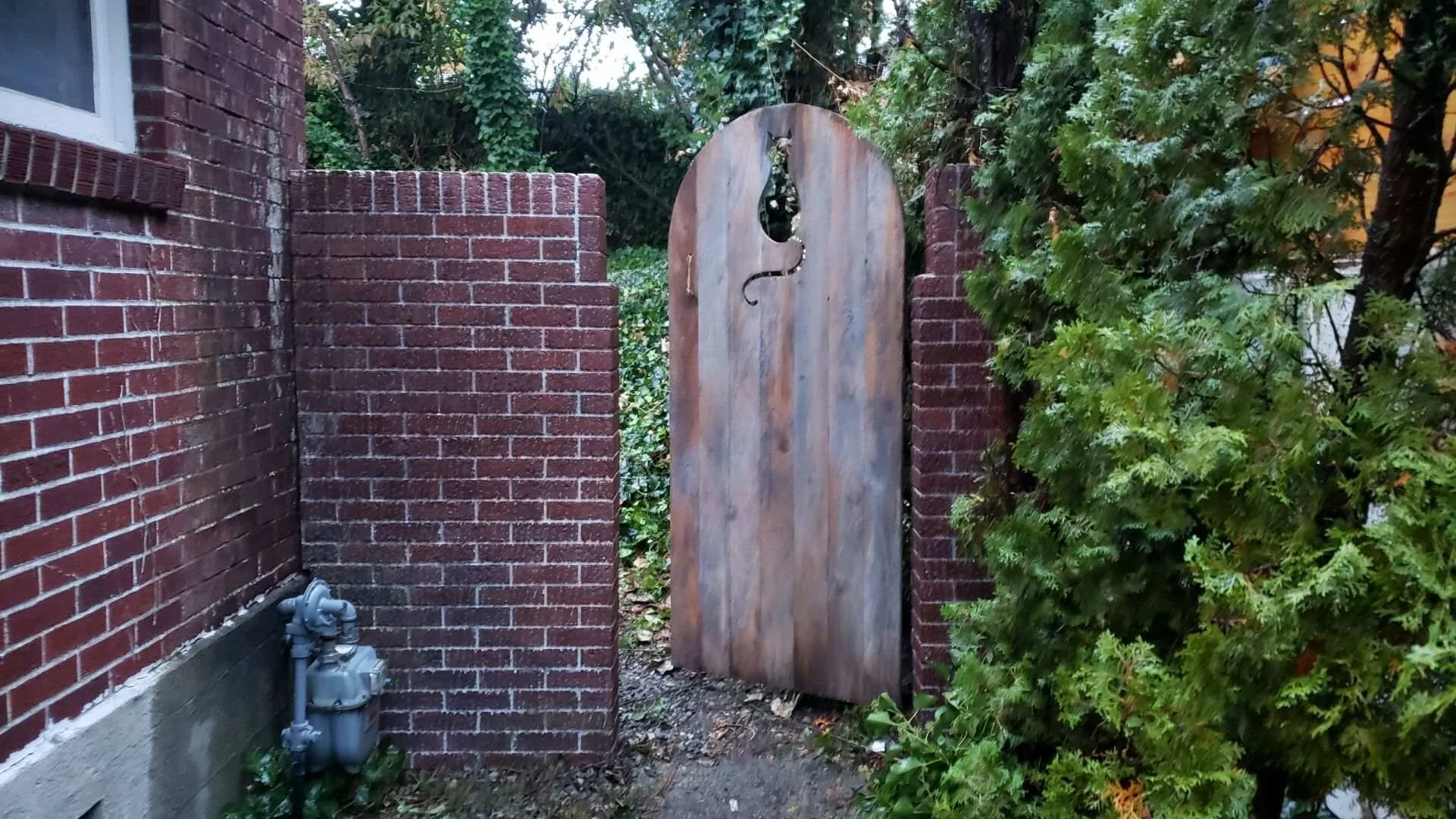 EXT EDITH'S HOUSE - BRICK WALL W/ GATE