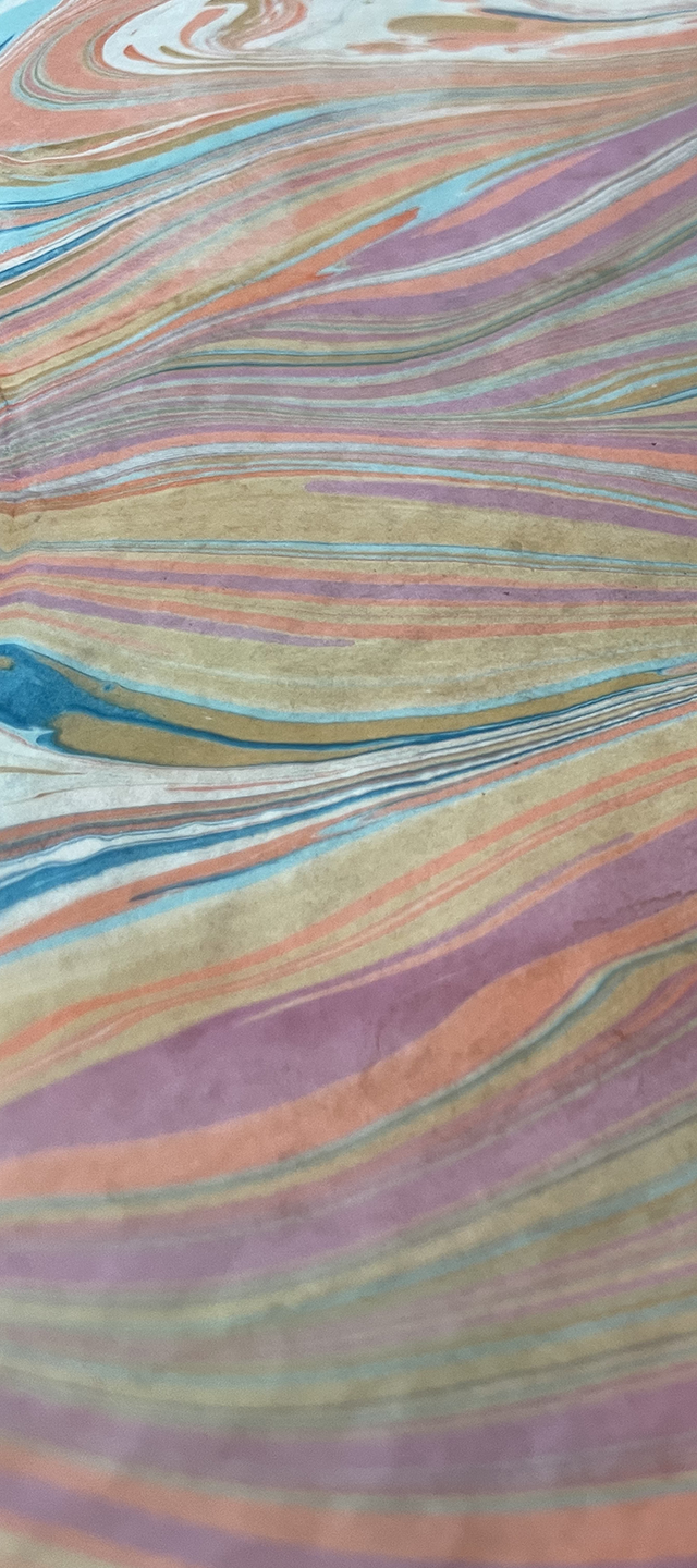 Close-up photo of colorful watercolor or ink on textured paper, with flowing, layered lines in shades of purple, pink, blue, beige, and green.