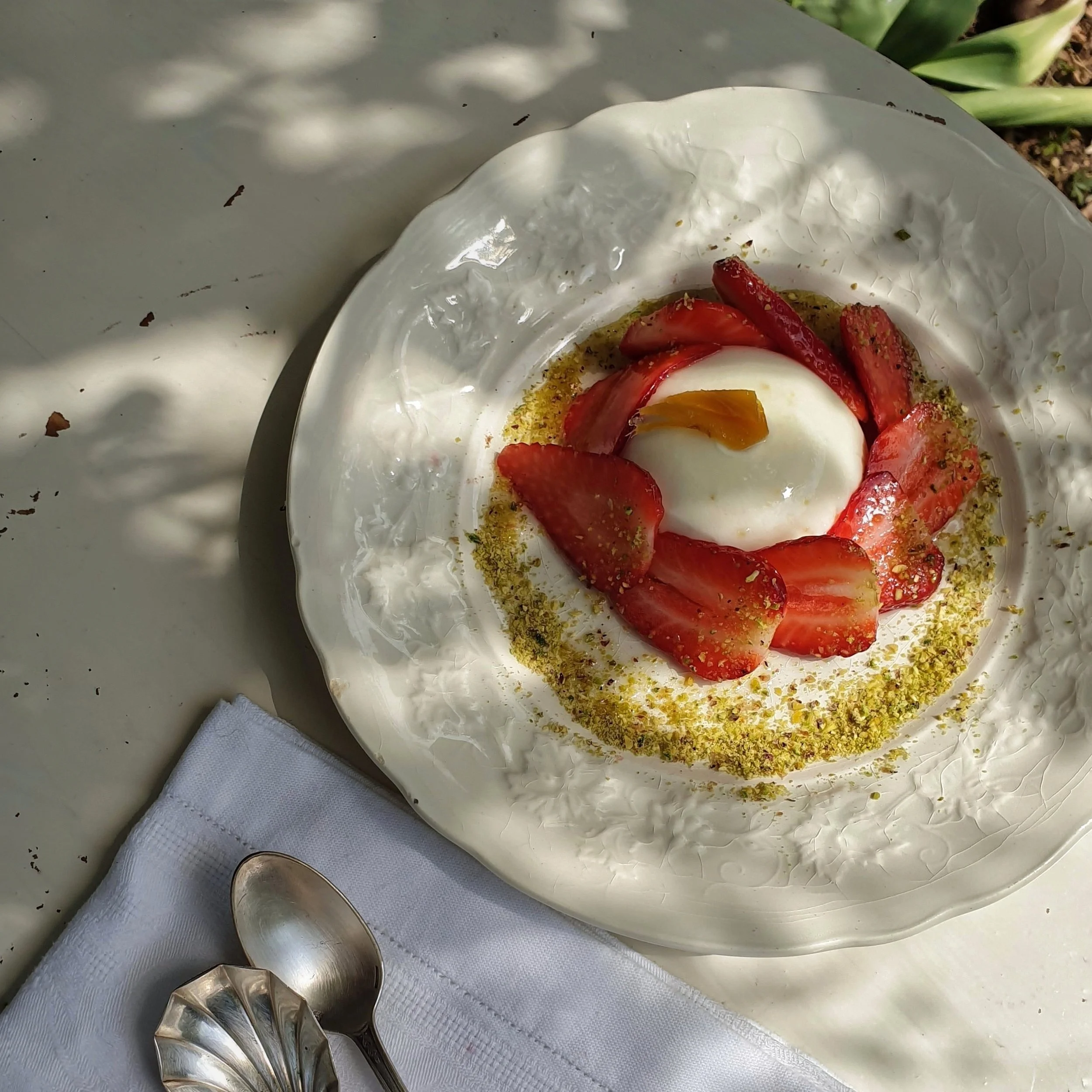 Vegetarian pannacotta with strawberries, ginger syrup and pistachios