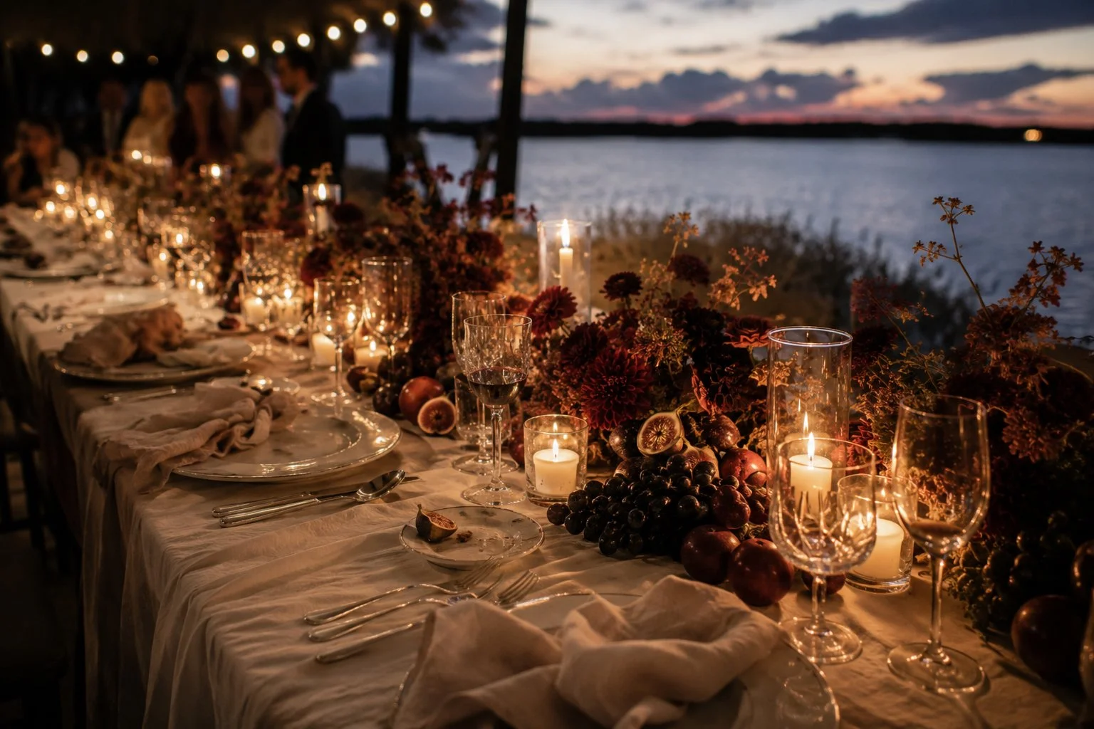 Luxury wedding reception in the Camargue, France, with an elegant candlelit dinner table overlooking the water at sunset, photographed in an editorial documentary style.