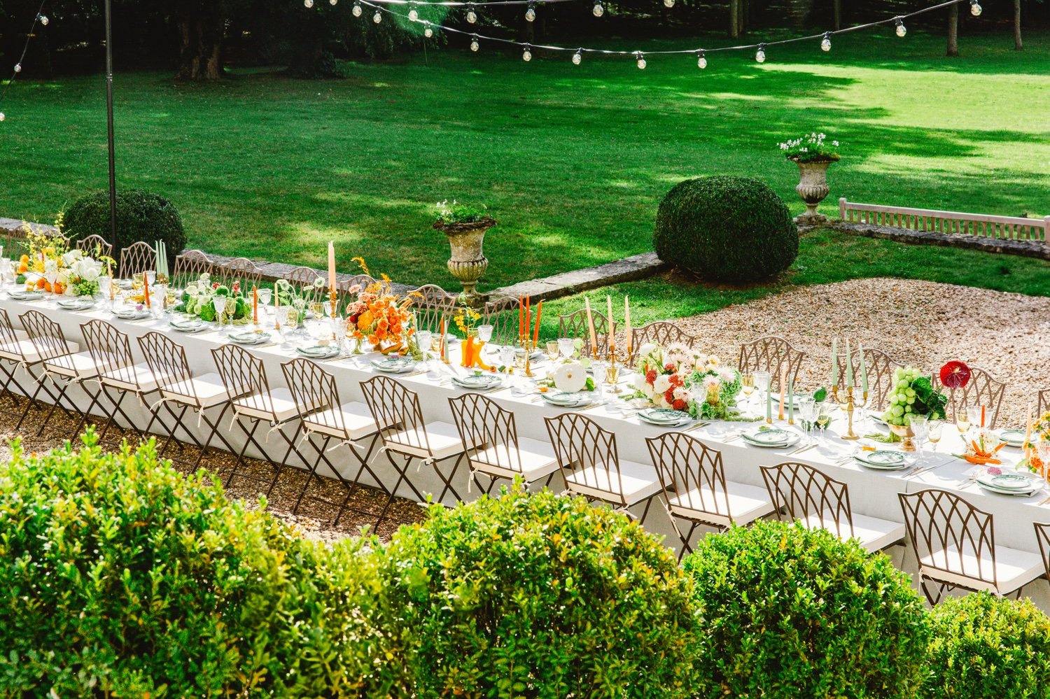 Summer wedding table set in the gardens of Château de Champlâtreux, France