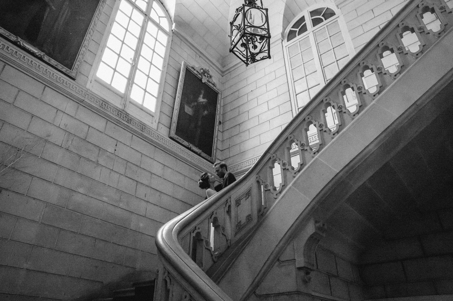 Wedding couple standing on the monumental staircase of Château de Baronville in France