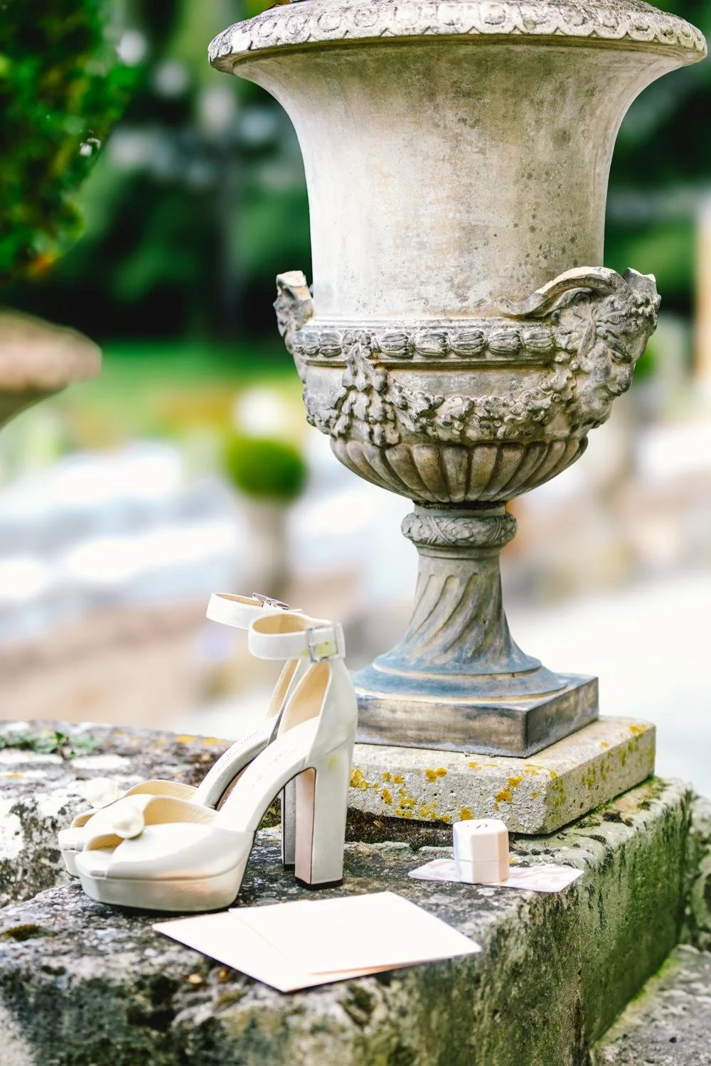 Bridal shoes and wedding details photographed in the gardens of Château de Champlâtreux near Paris