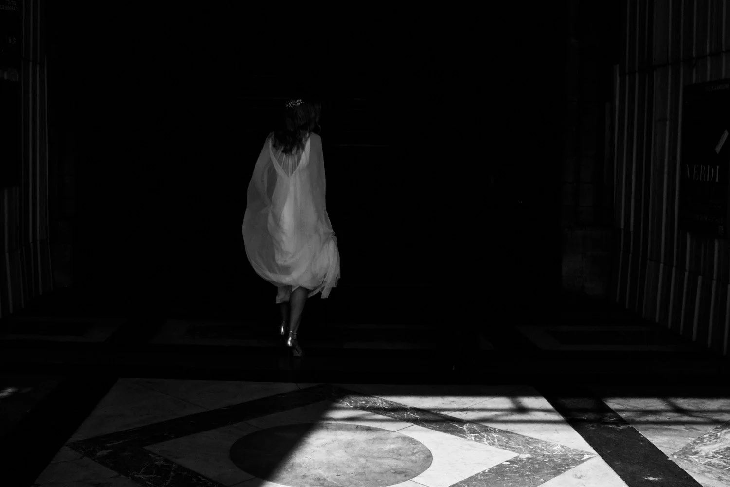 Bride walking through a beam of light inside La Madeleine Church in Paris, France