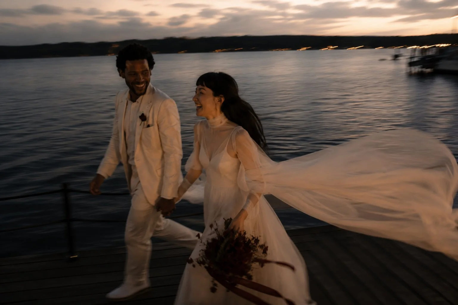 Bride and groom walking hand in hand at sunset after their luxury destination wedding in the Camargue, France.