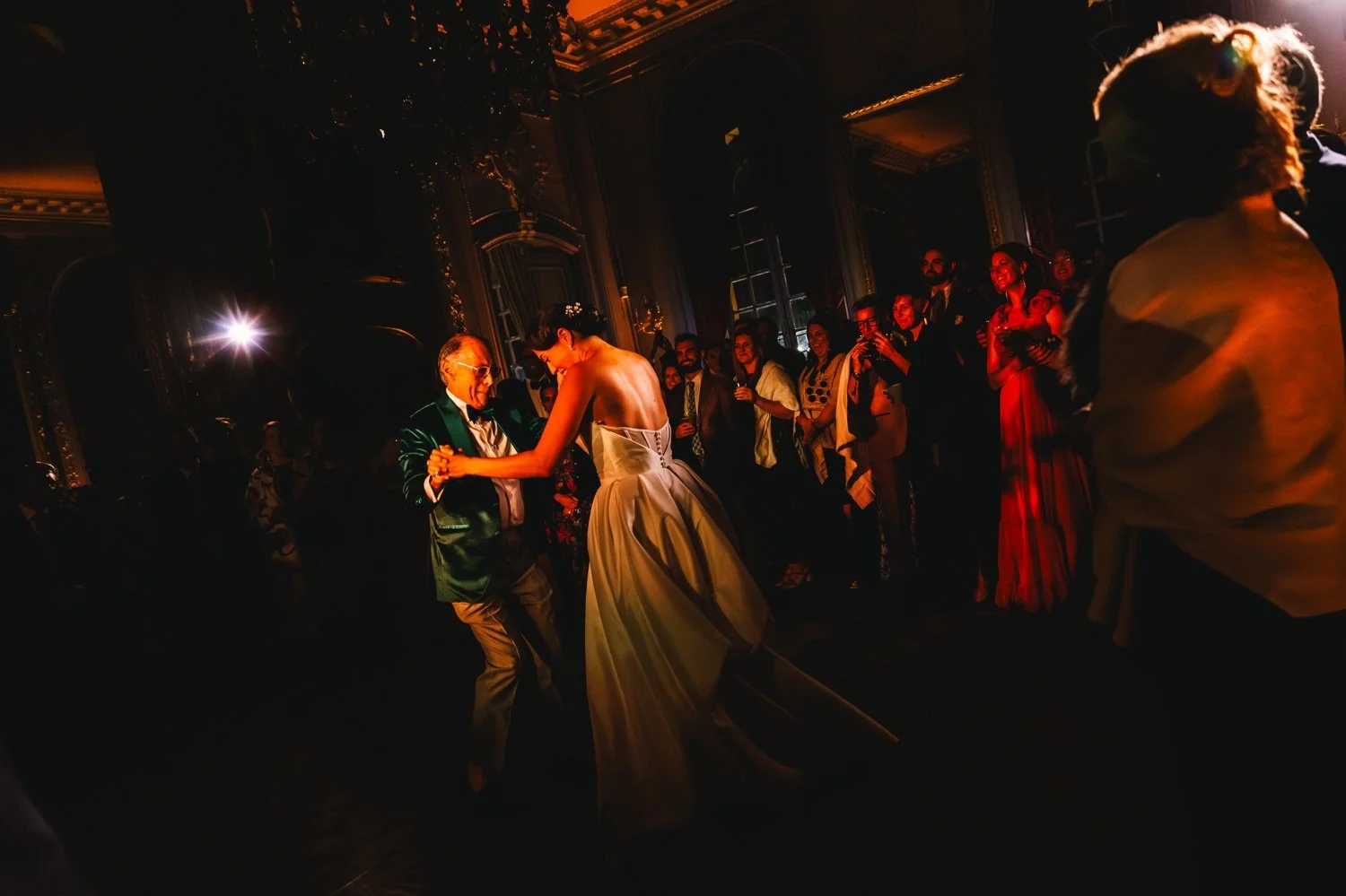 Bride dancing with her father during a wedding celebration at Château de Vaux-le-Vicomte in France