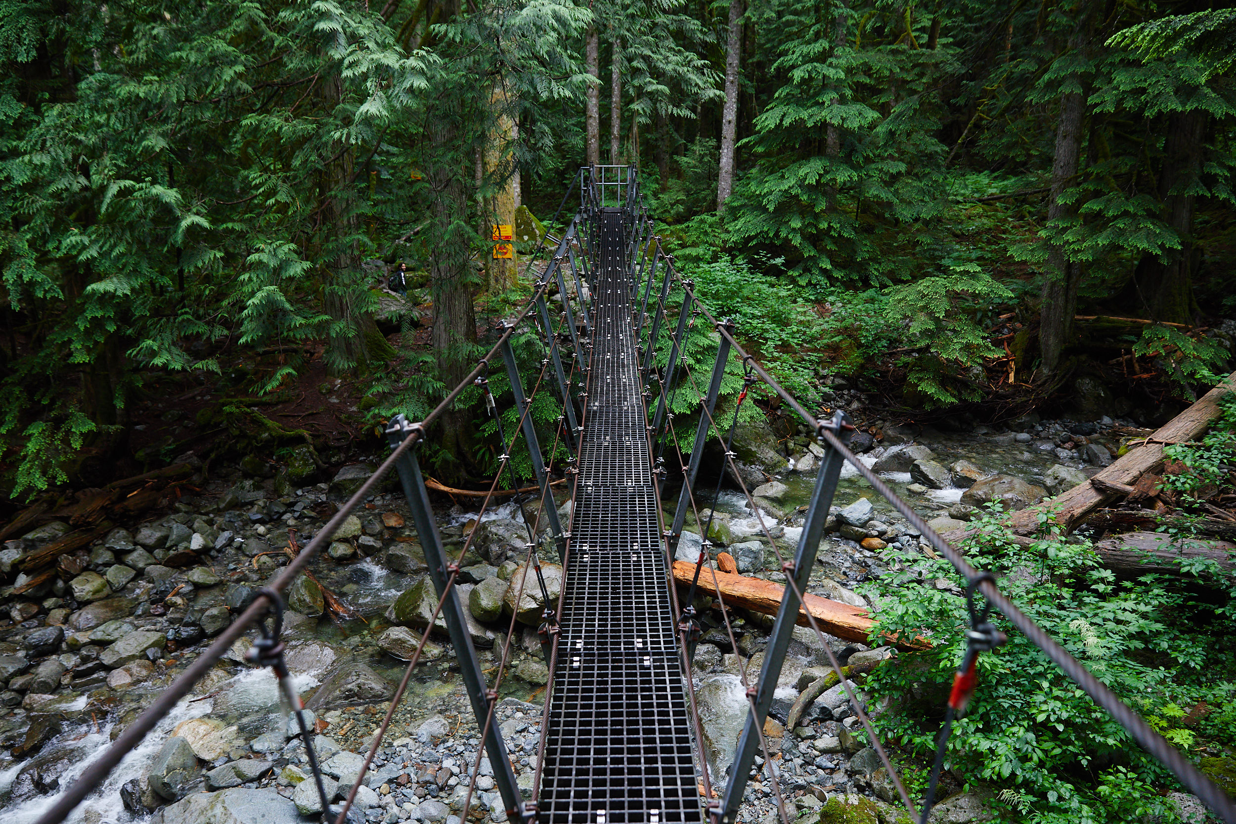  After the waterfall, you cross a wire bridge and continue into the valley. 