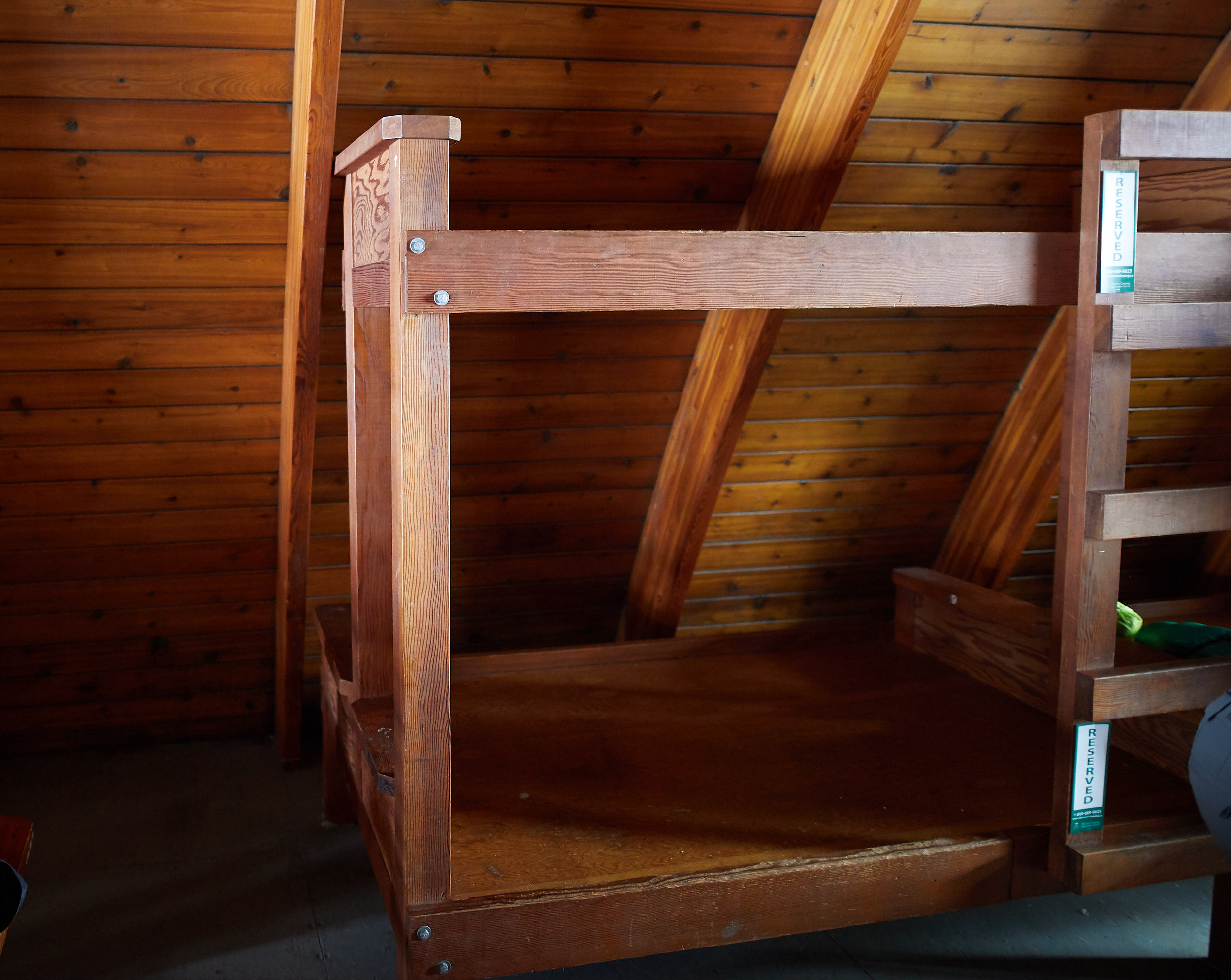  The hut is lined with bunk beds, with the bottoms being doubles and the tops being singles. 