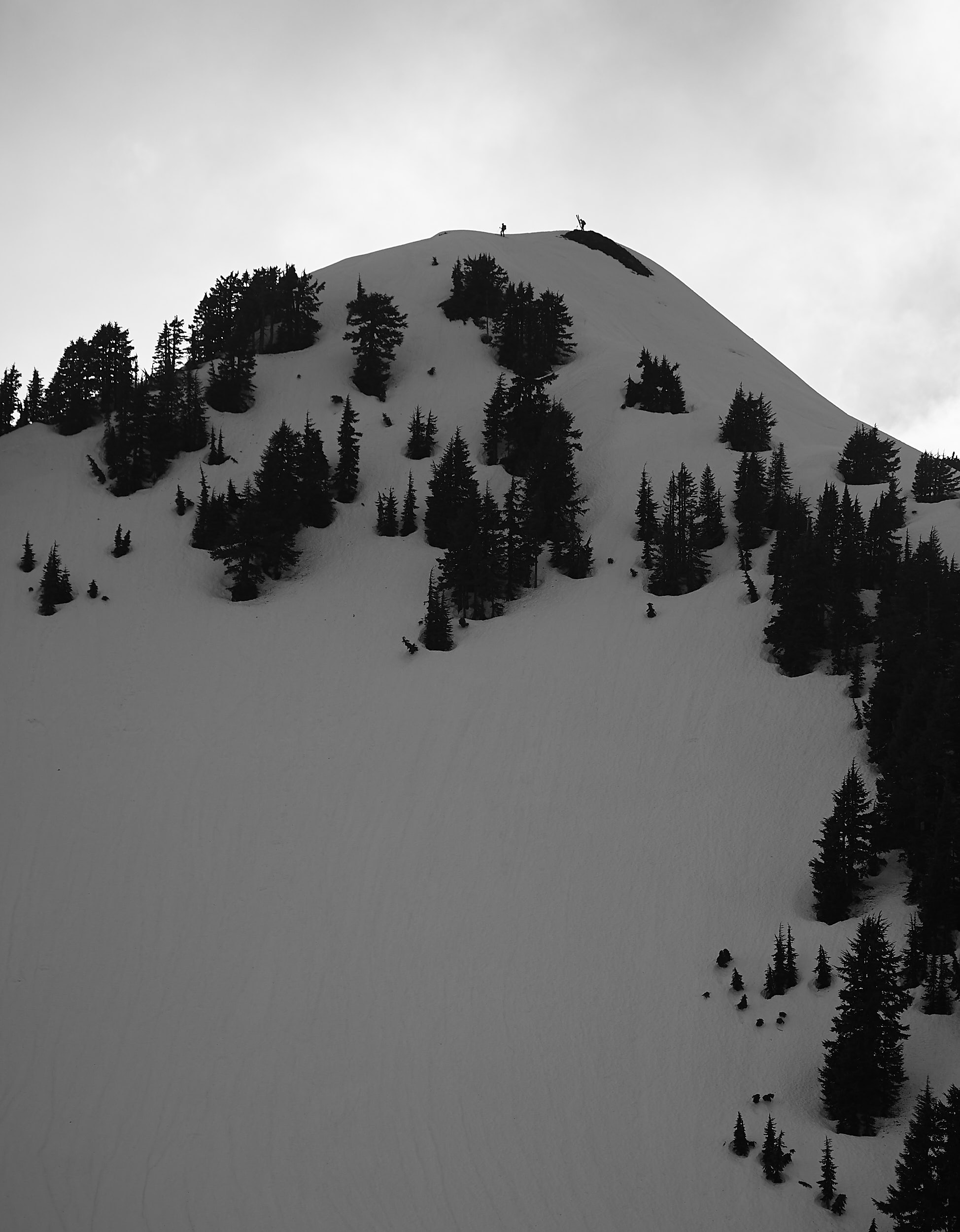  Two of the people staying in the hut can be seen here at the top of nearby peak ready to ski down. 
