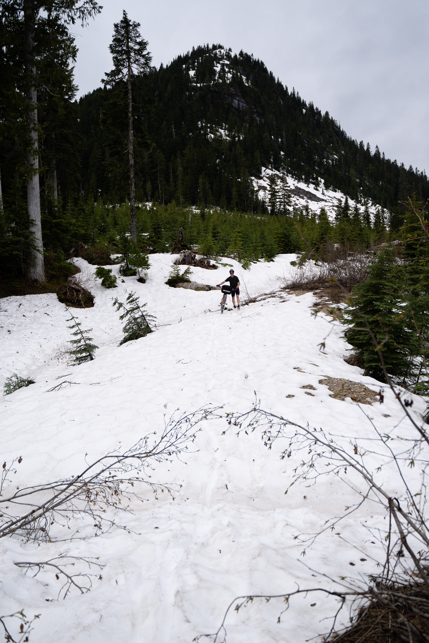  At the peak, we were met with a foot or two of snow. It was pretty slow going hiking the bikes up and down through the 2km that it covered. 